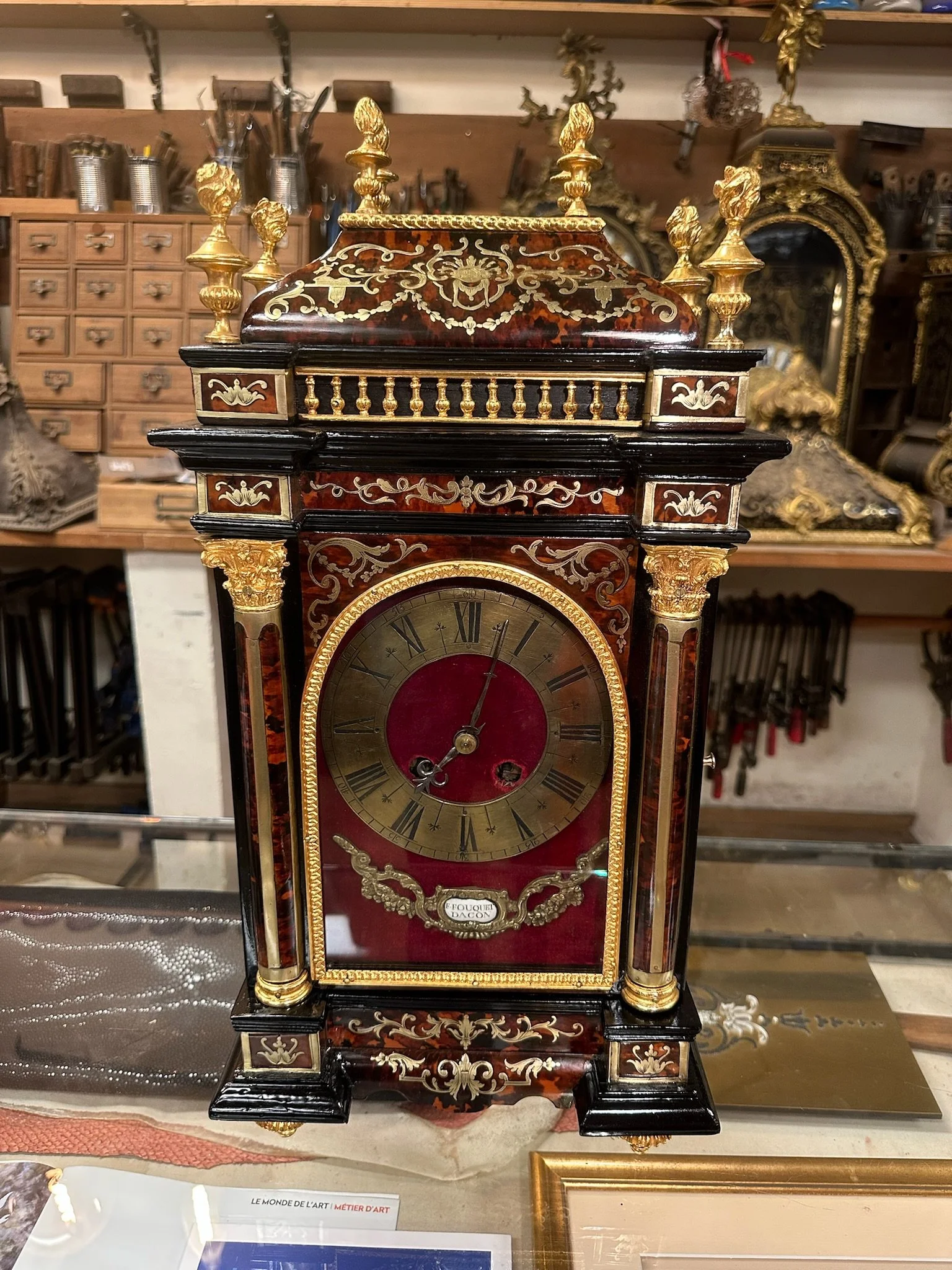 Pendule religieuse en écaille rouge et laiton