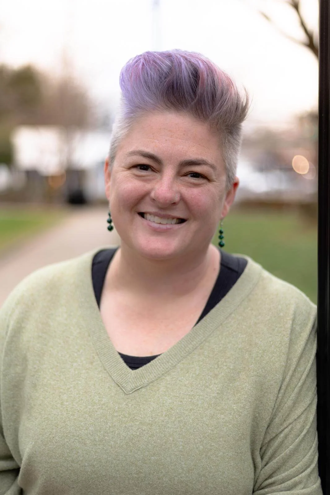 Next Phase Doula Care founder and postpartum doula Wendy Black wears a light green shirt and smiles warmly.