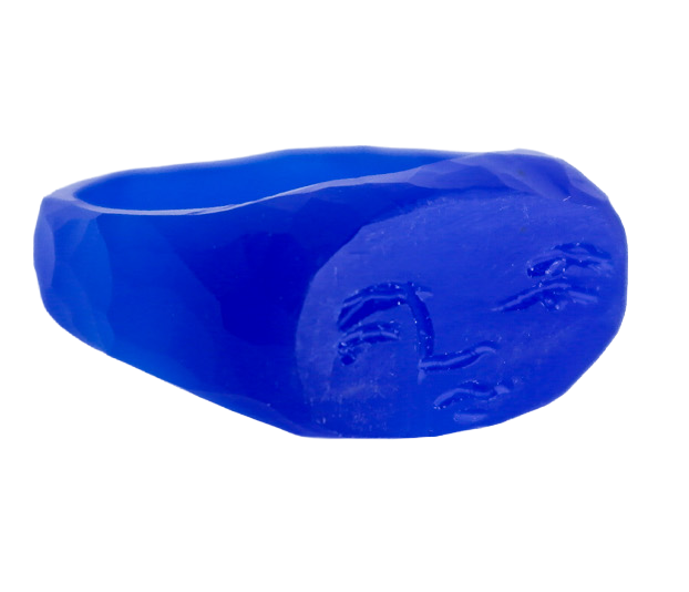 A blue, irregularly shaped object with faces carved into its surface, set against a black background.