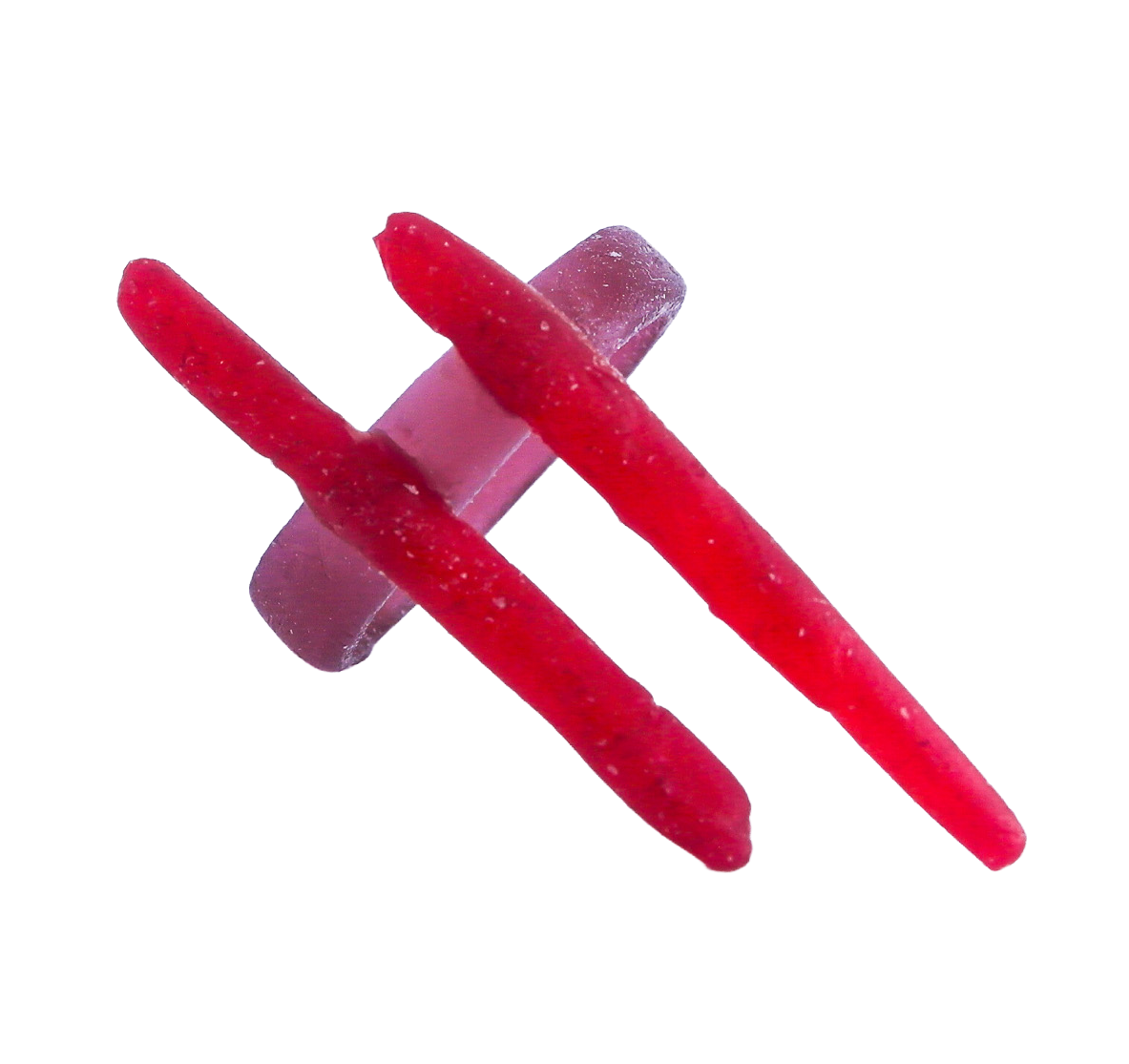 Two red Chewy candy sticks crossed on top of a clear plastic clip, isolated on a black background.