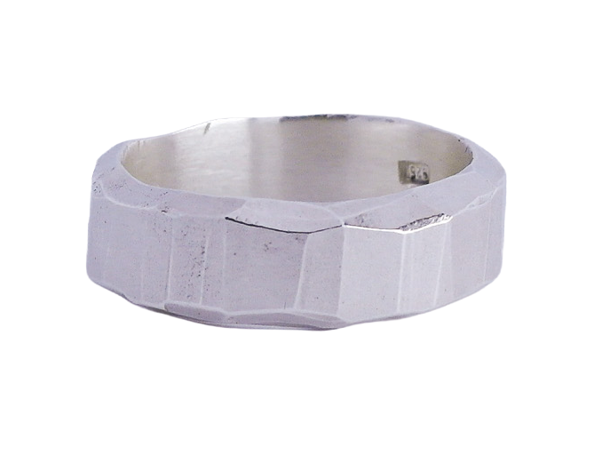 A silver metallic ring with a textured surface. Casted from hand carved wax ring.