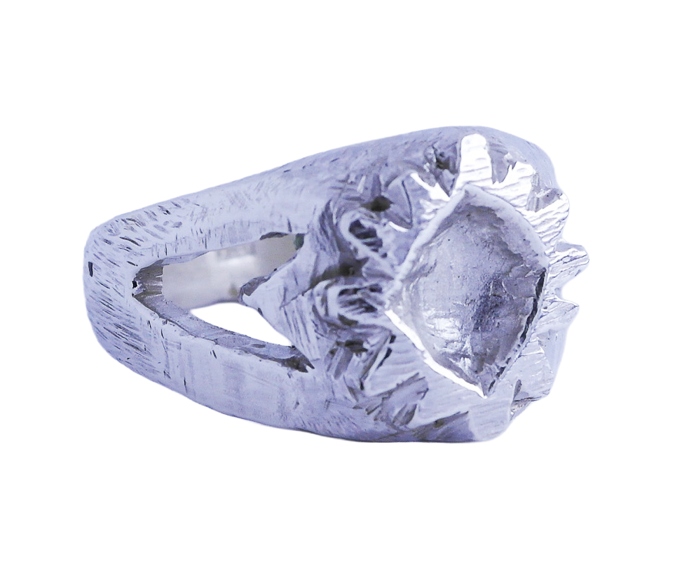 A silver metallic ring with a textured surface. Casted from hand carved wax ring.