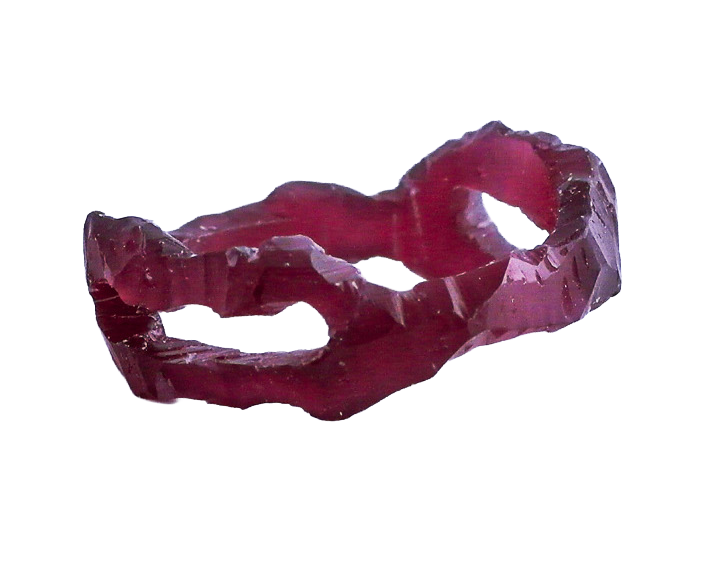 A dark-colored, irregularly shaped hand carved wax ring.