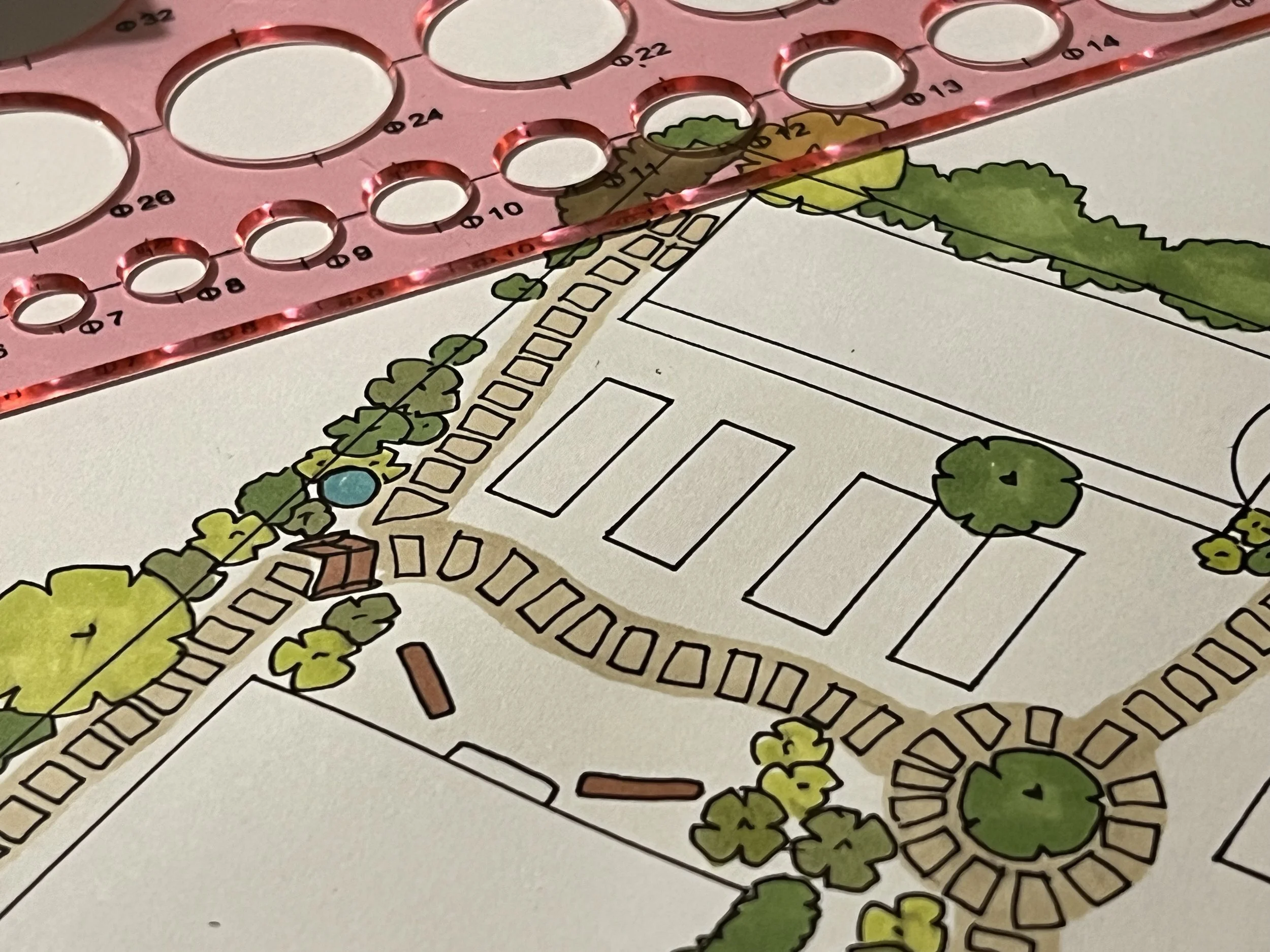 A detailed garden landscape plan, including trees, pathways, and planting beds, with a pink circle template for measurements.