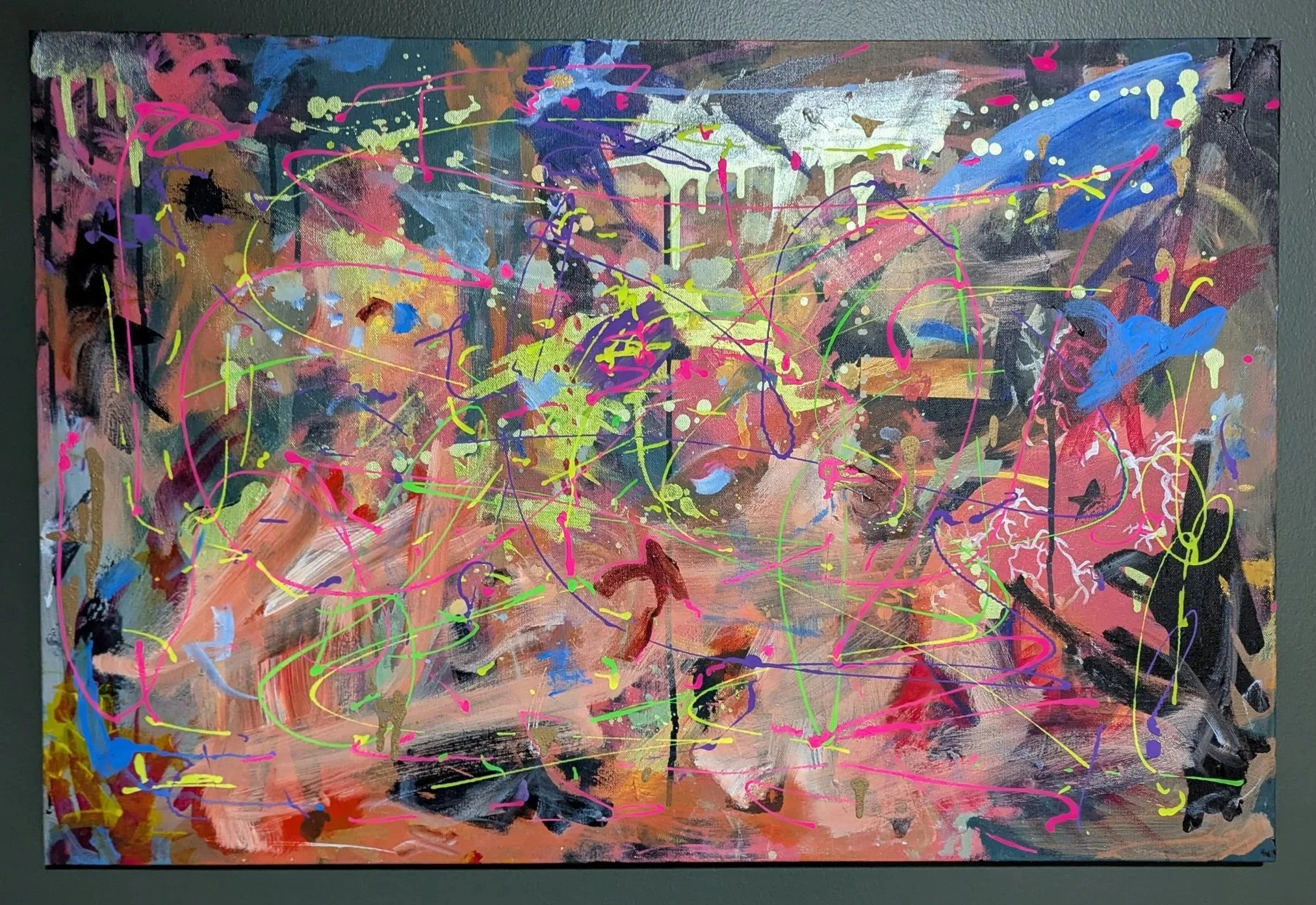 Abstract expressionist painting with splashes of bright colors like pink, green, blue, yellow, black, and white on a textured background.