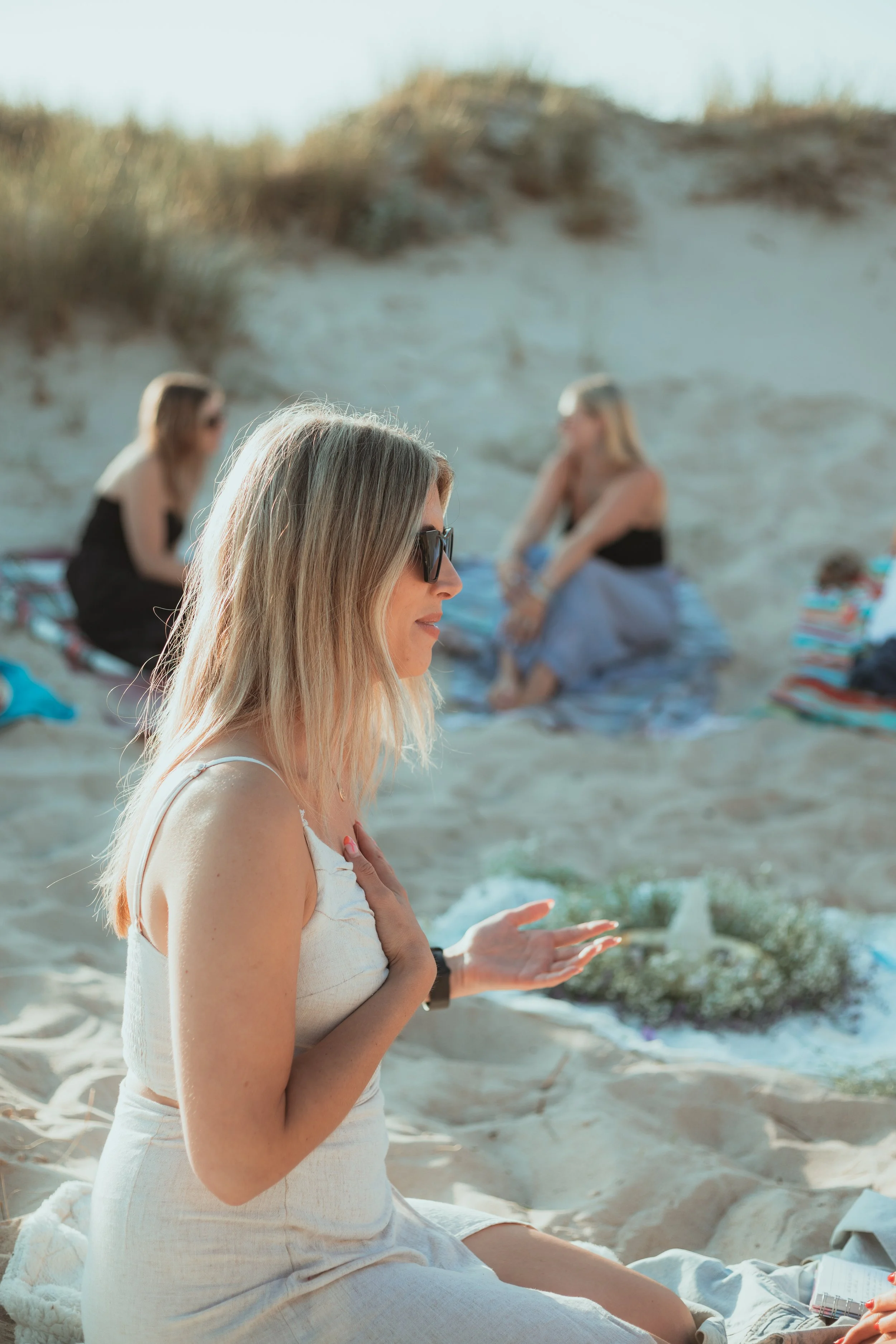 A women's circle on the beach
