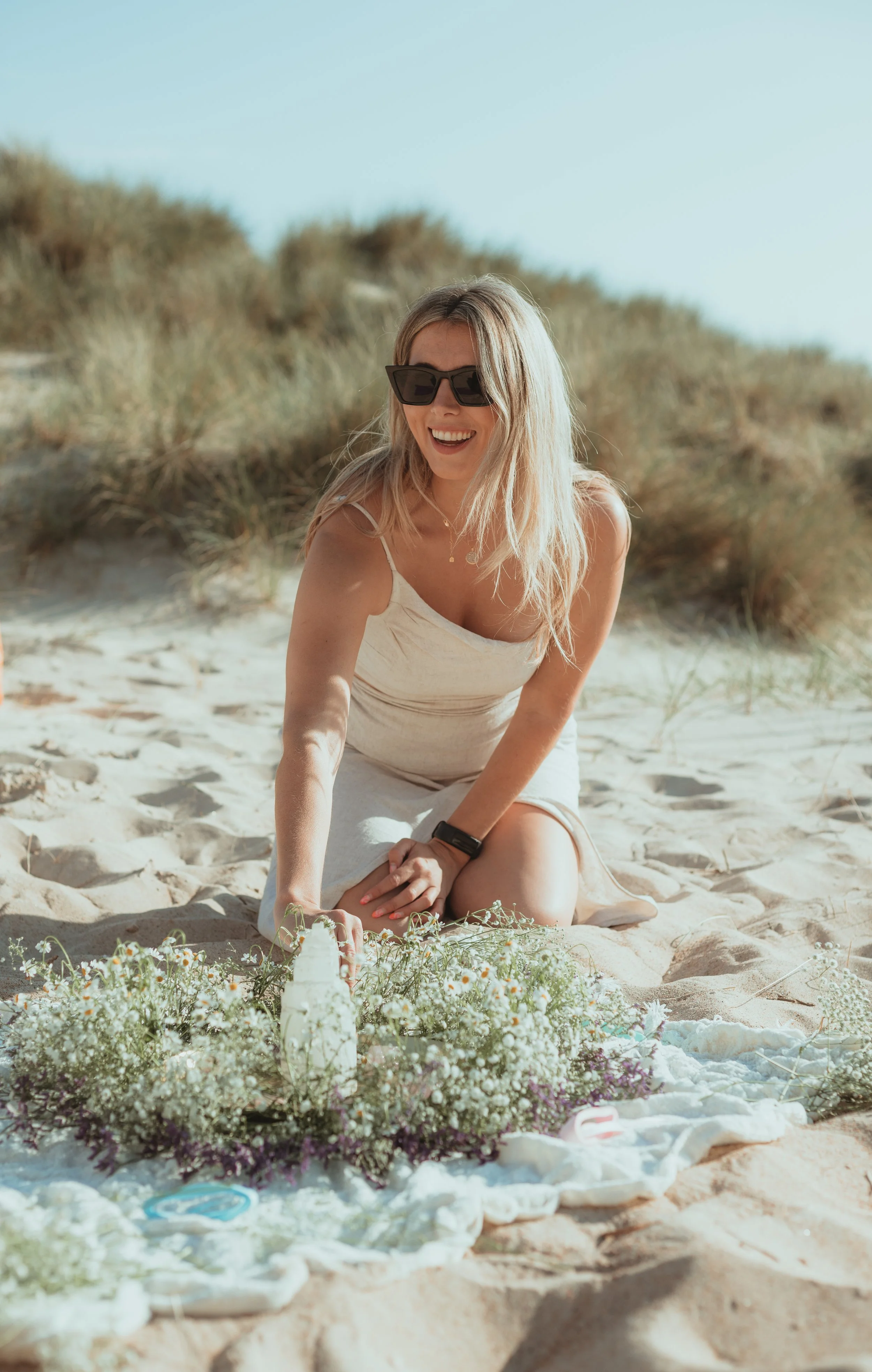 A women preparing an altar with flowers and candles at a women's circle