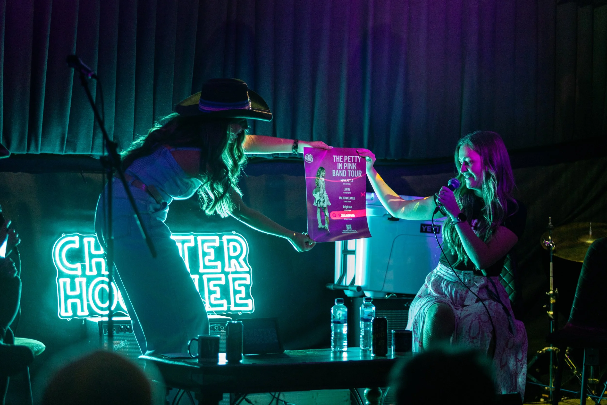 Louise Parker performing live at a country pop gig in Essex, UK singer-songwriter on stage engaging the audience during a live music event