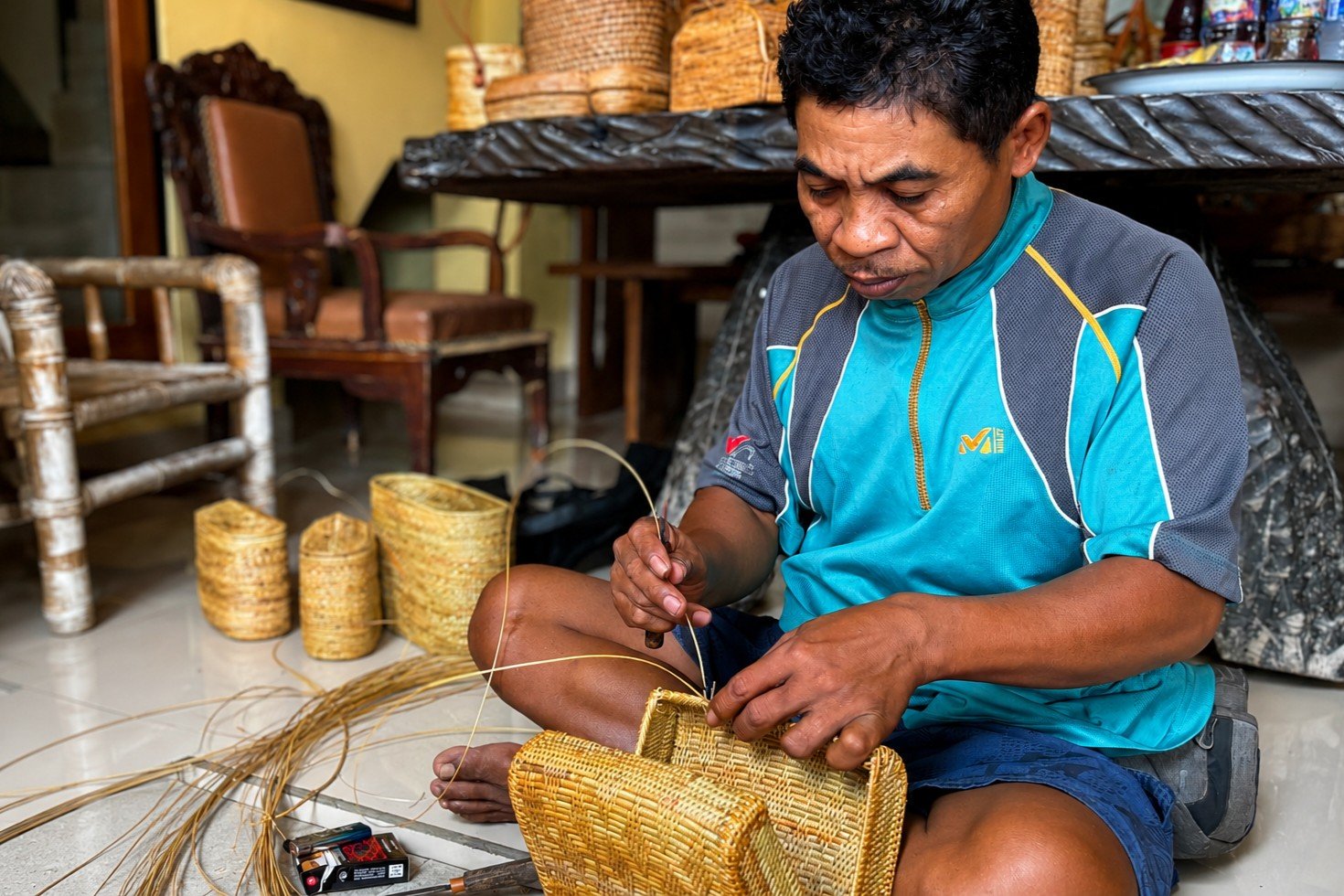 A Balinese artisan handweaves each bag into a unique shape and pattern.