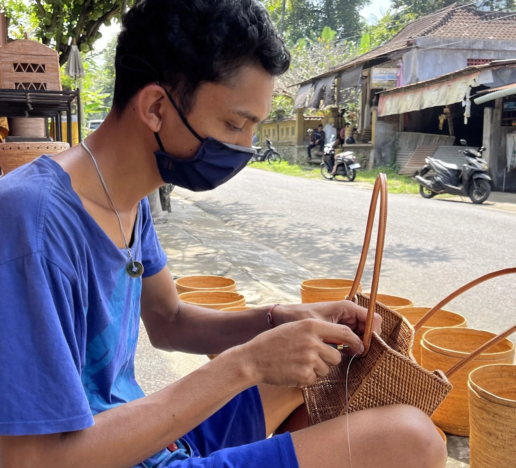 A Balinese artisan woven a shoulder bag from ata grass