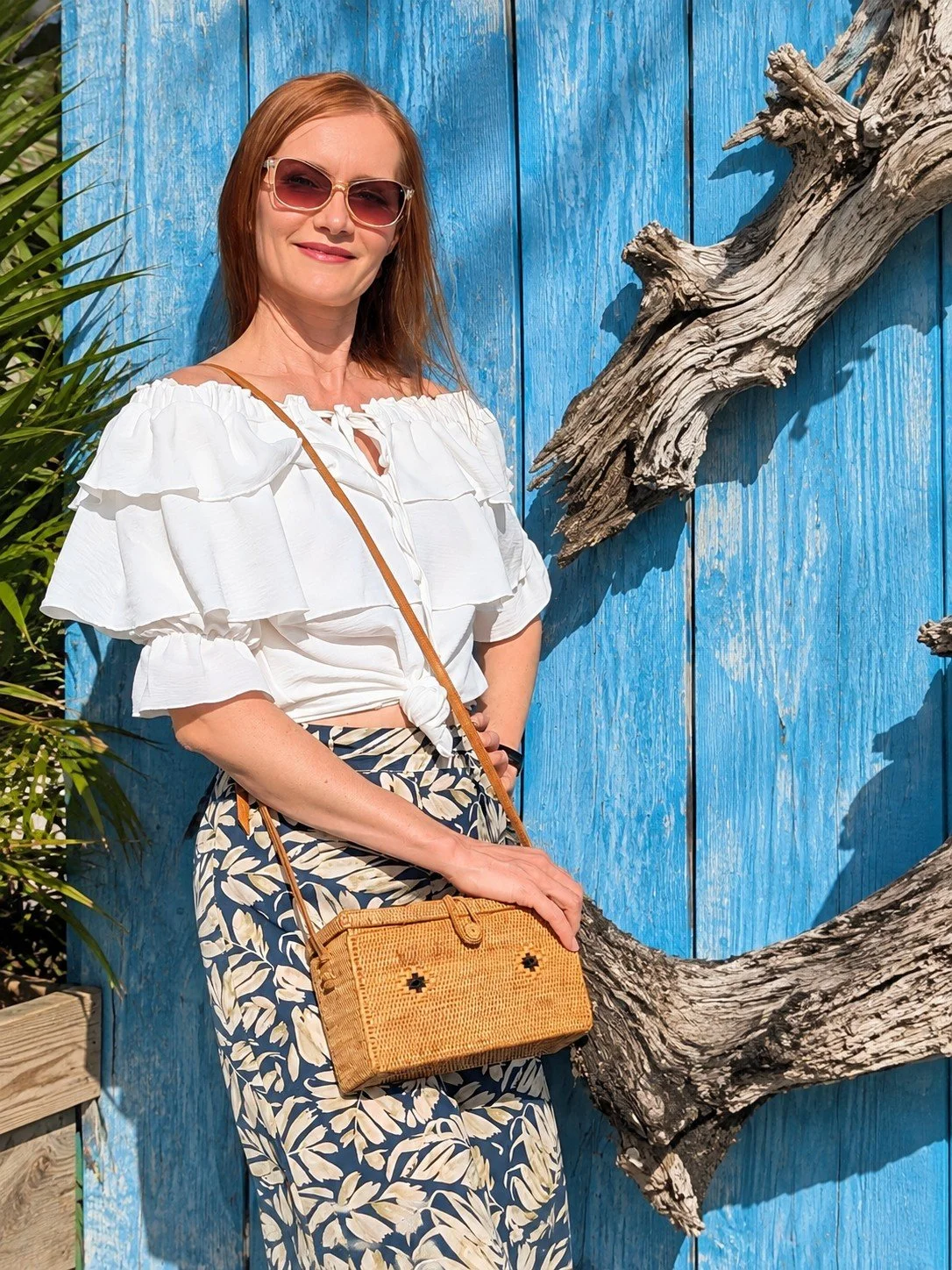 Woman wearing the Vintage Vibe woven rattan crossbody for summer vacation