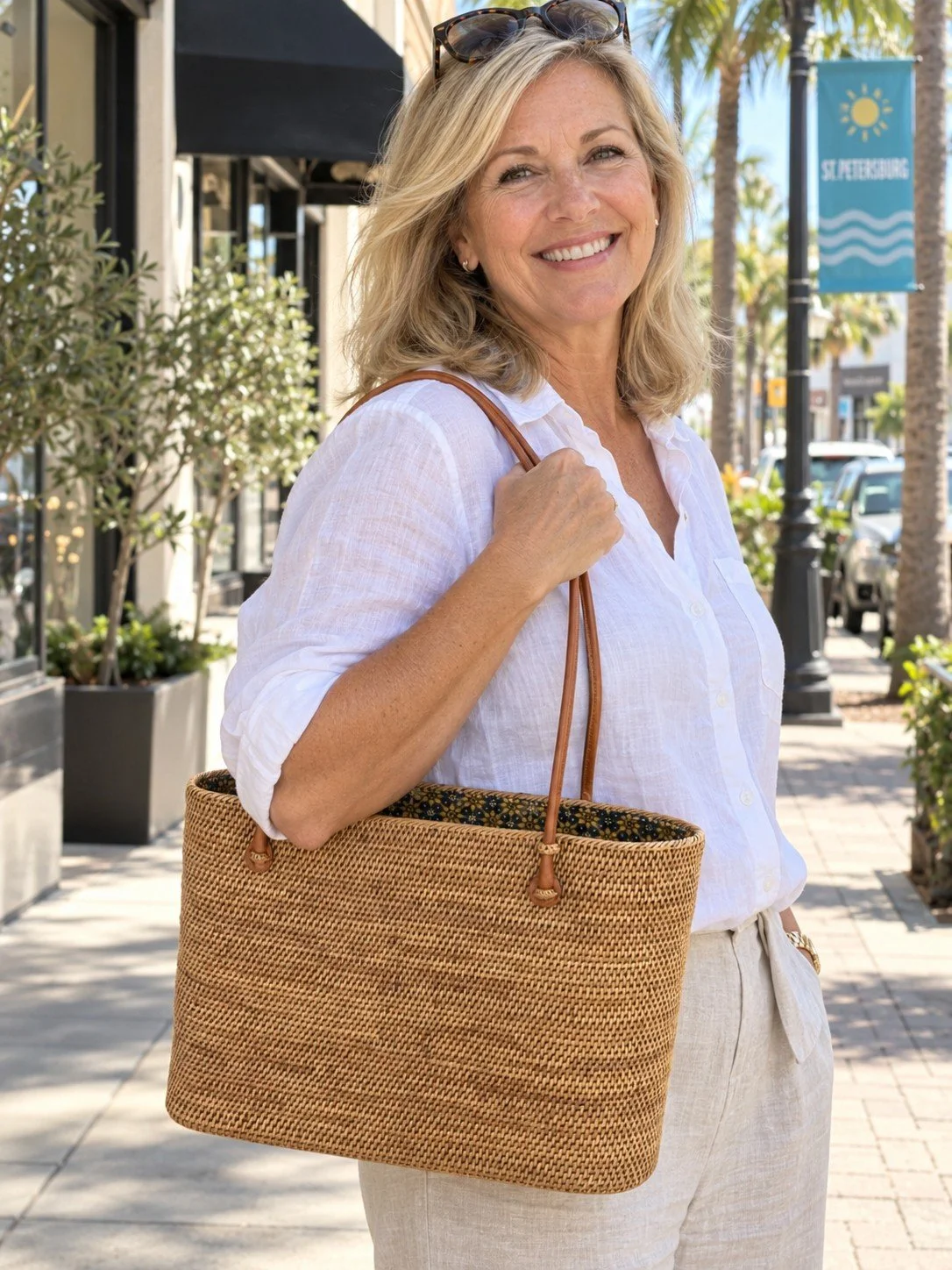 Woman carrying the Big Straw Bag woven tote for daily errands