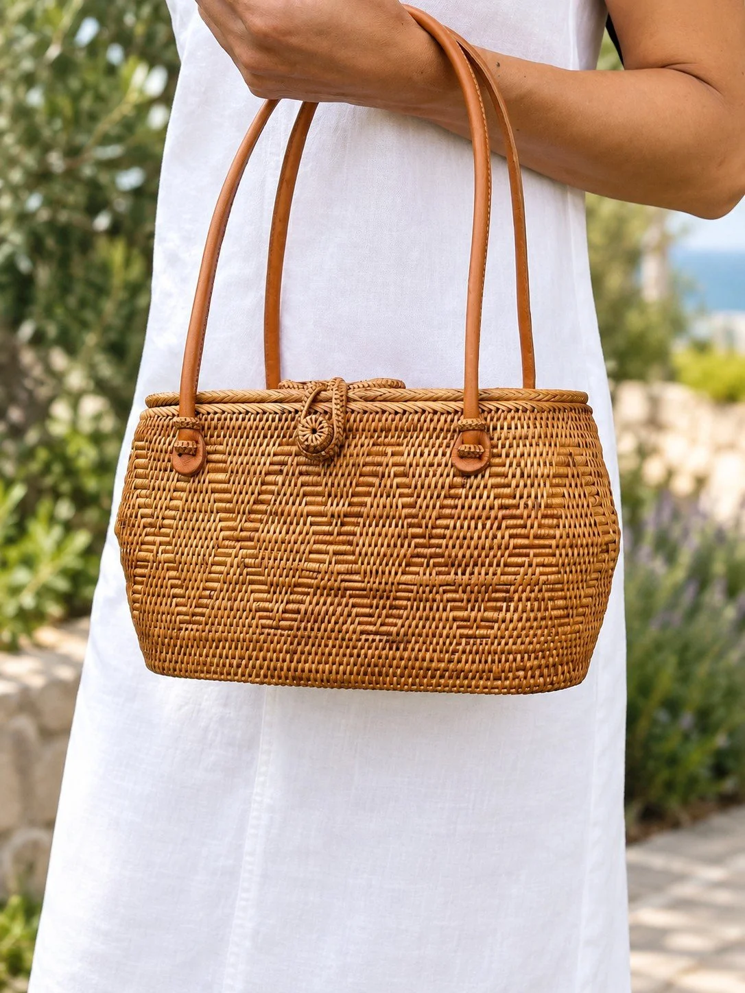 Woman holding the Totally Chic summer wicker purse