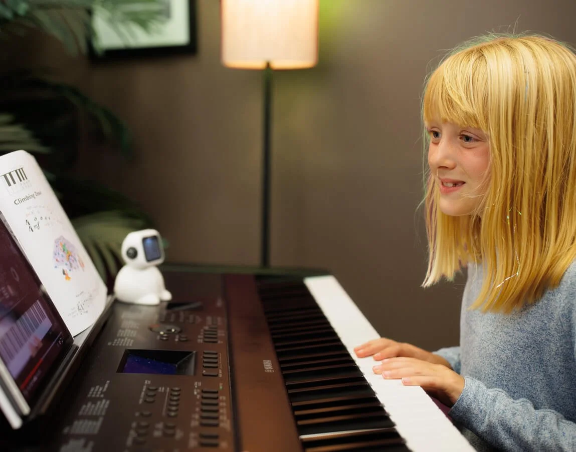young piano student practicing at home