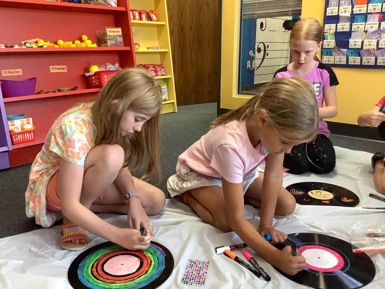 young girls coloring records during summer music camp in Arrow studio