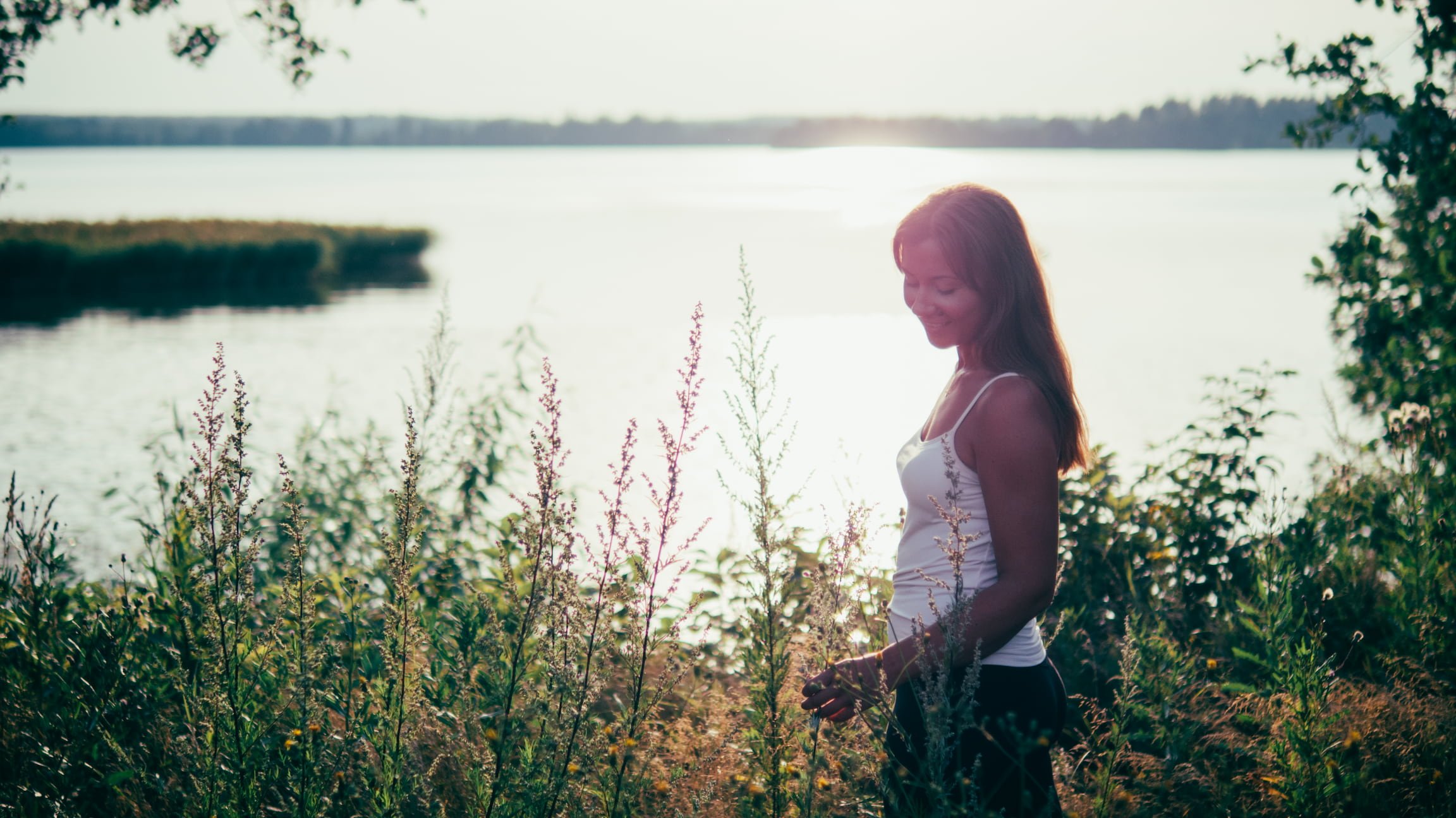 Wellness professional in tall grass and wildflowers