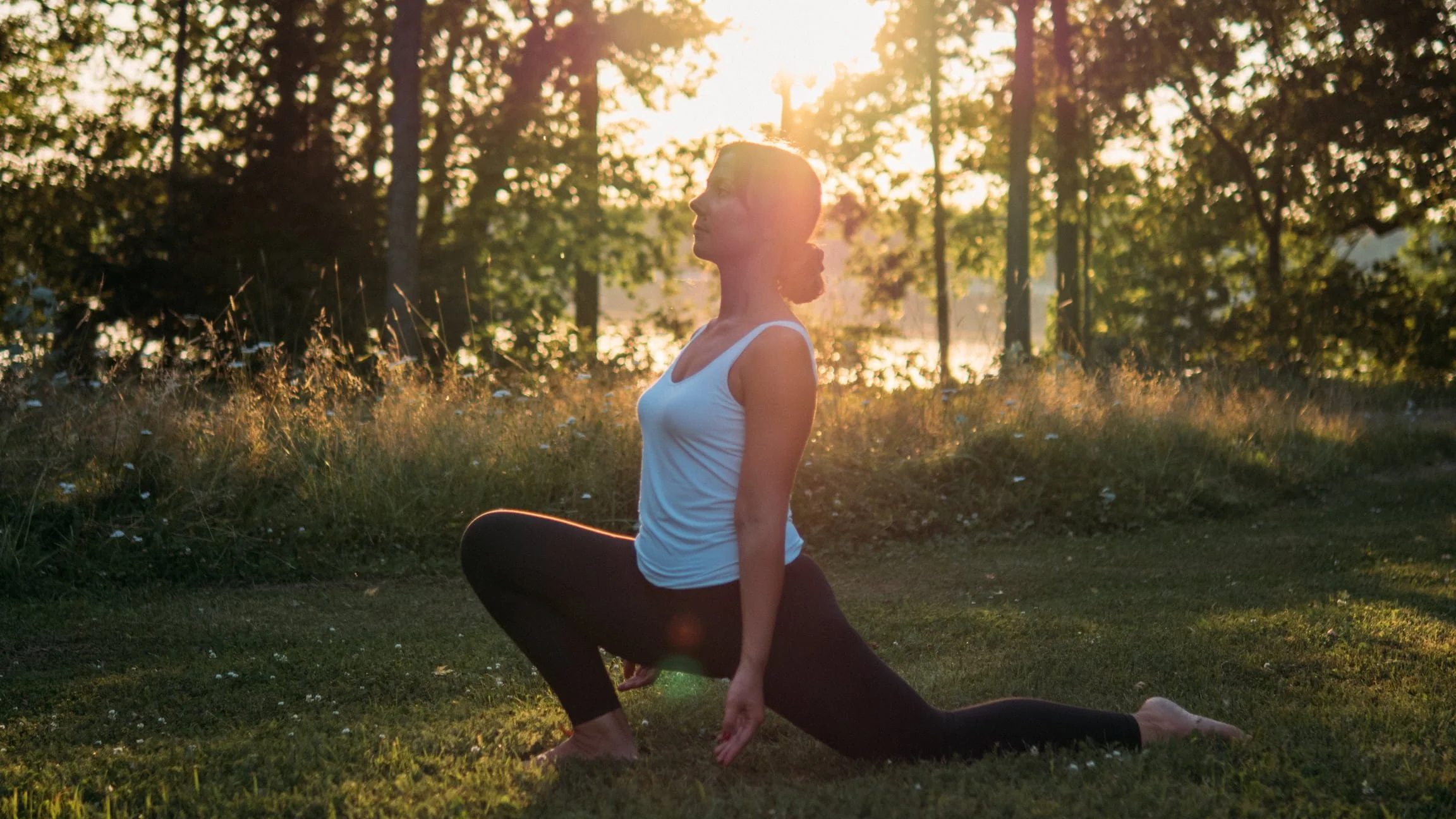 Yoga instructor Vilma practicing on the grass
