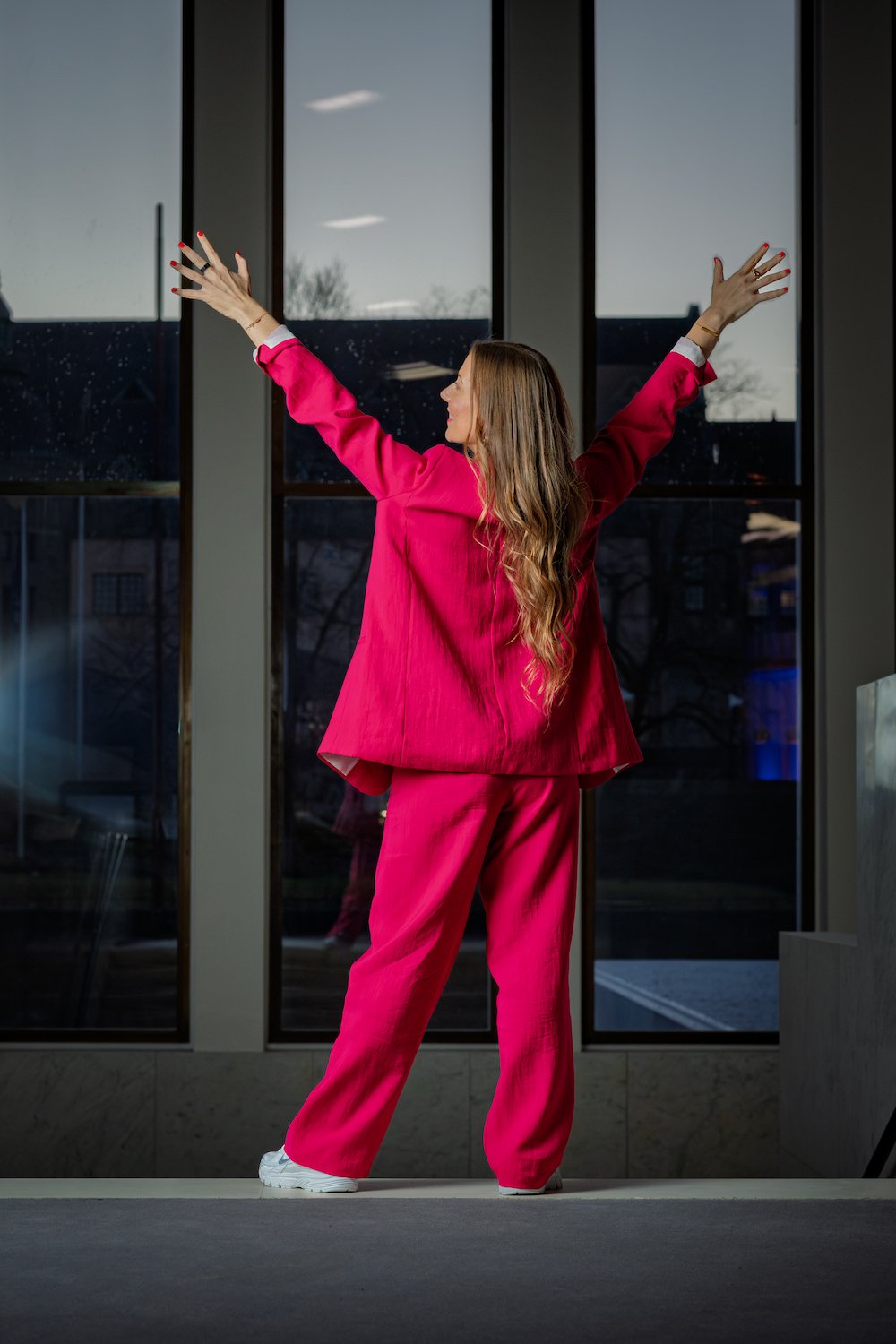 Presenter with arms up, back view