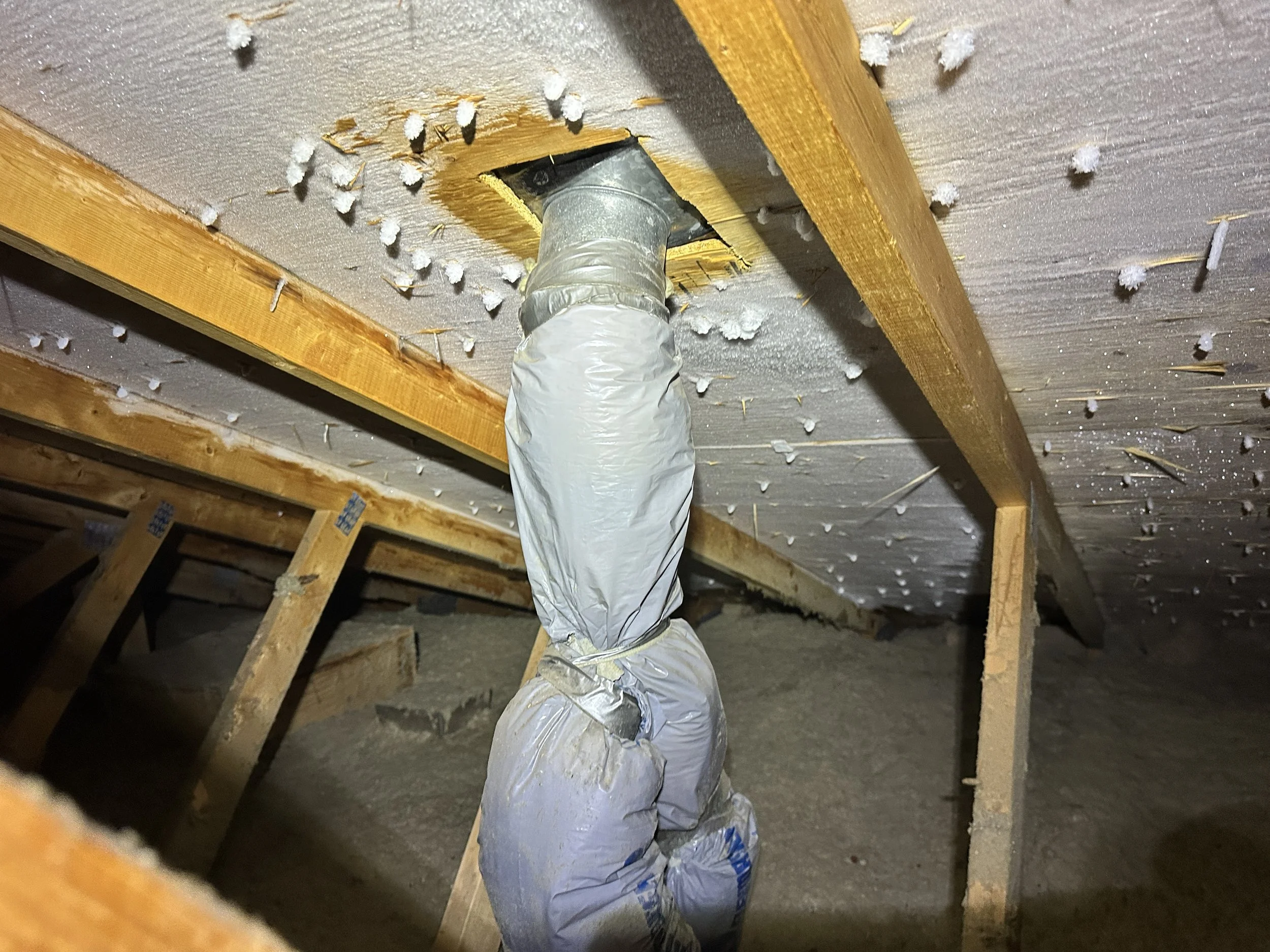 Ice built up on the roof deck due to condensation and an exhaust vent leak, also called attic rain.