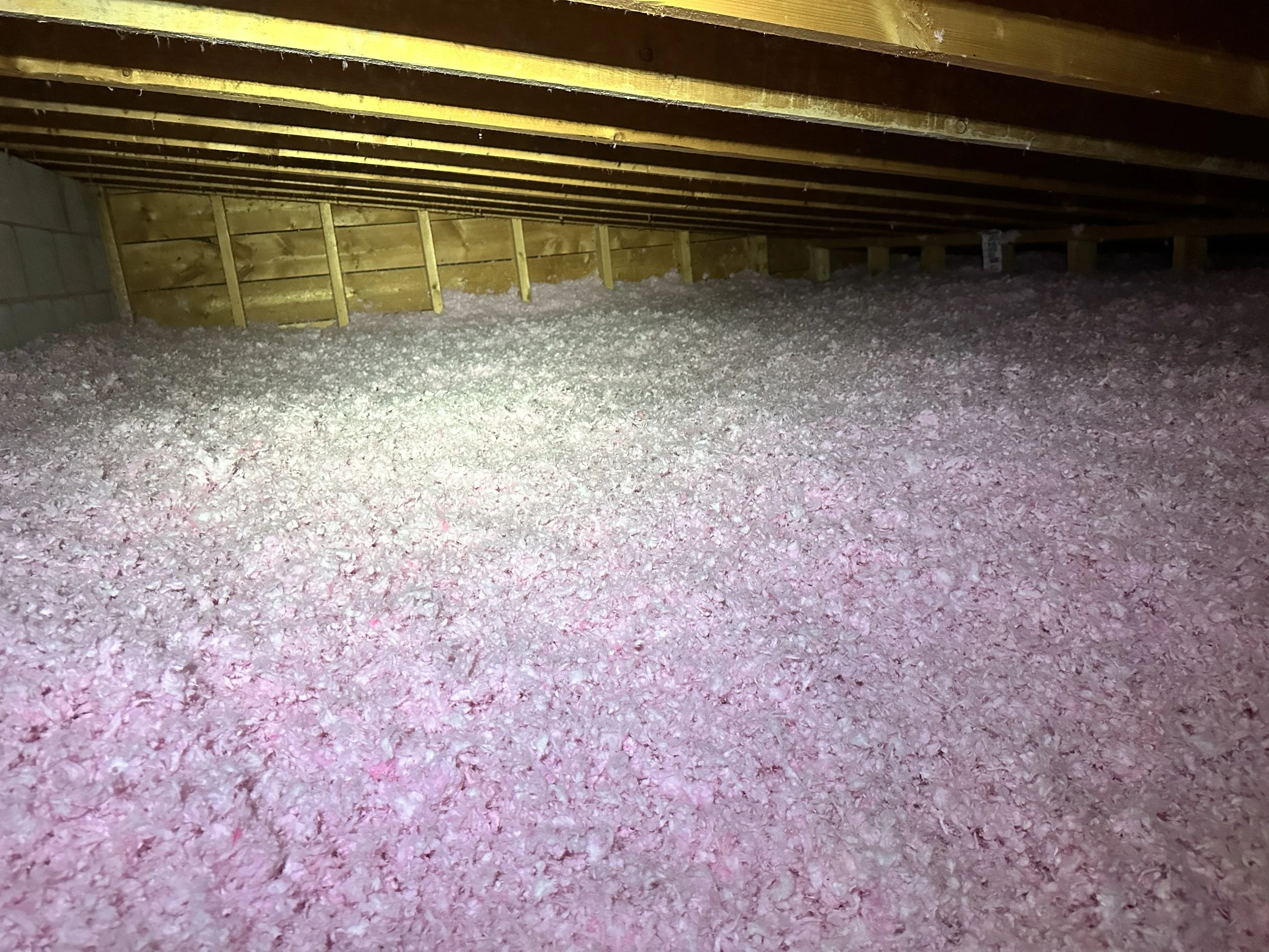 fiberglass insulation material in an attic.