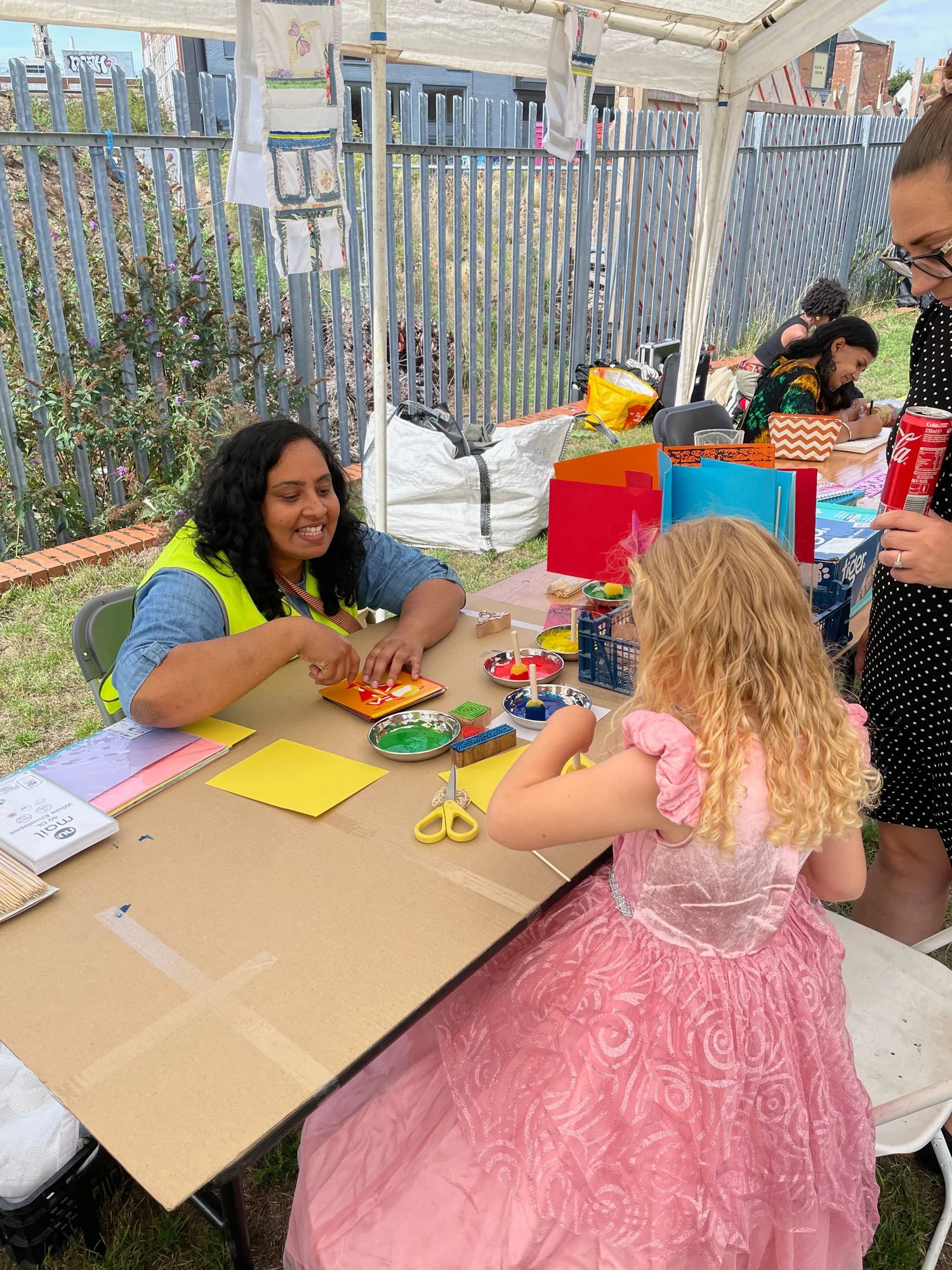 Anisha encouraging a young participant.