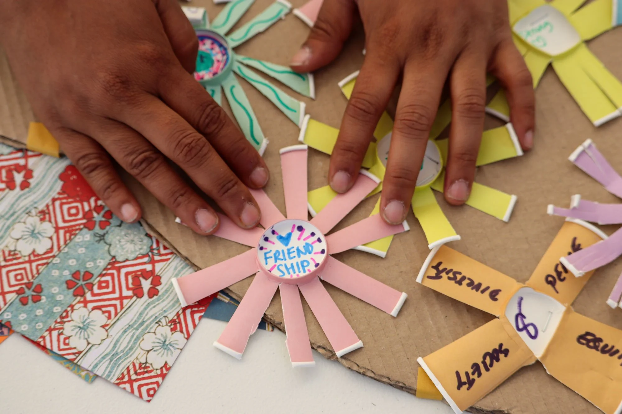Some of the paper tea cups cut, drawn/written and stuck onto the community teapot.