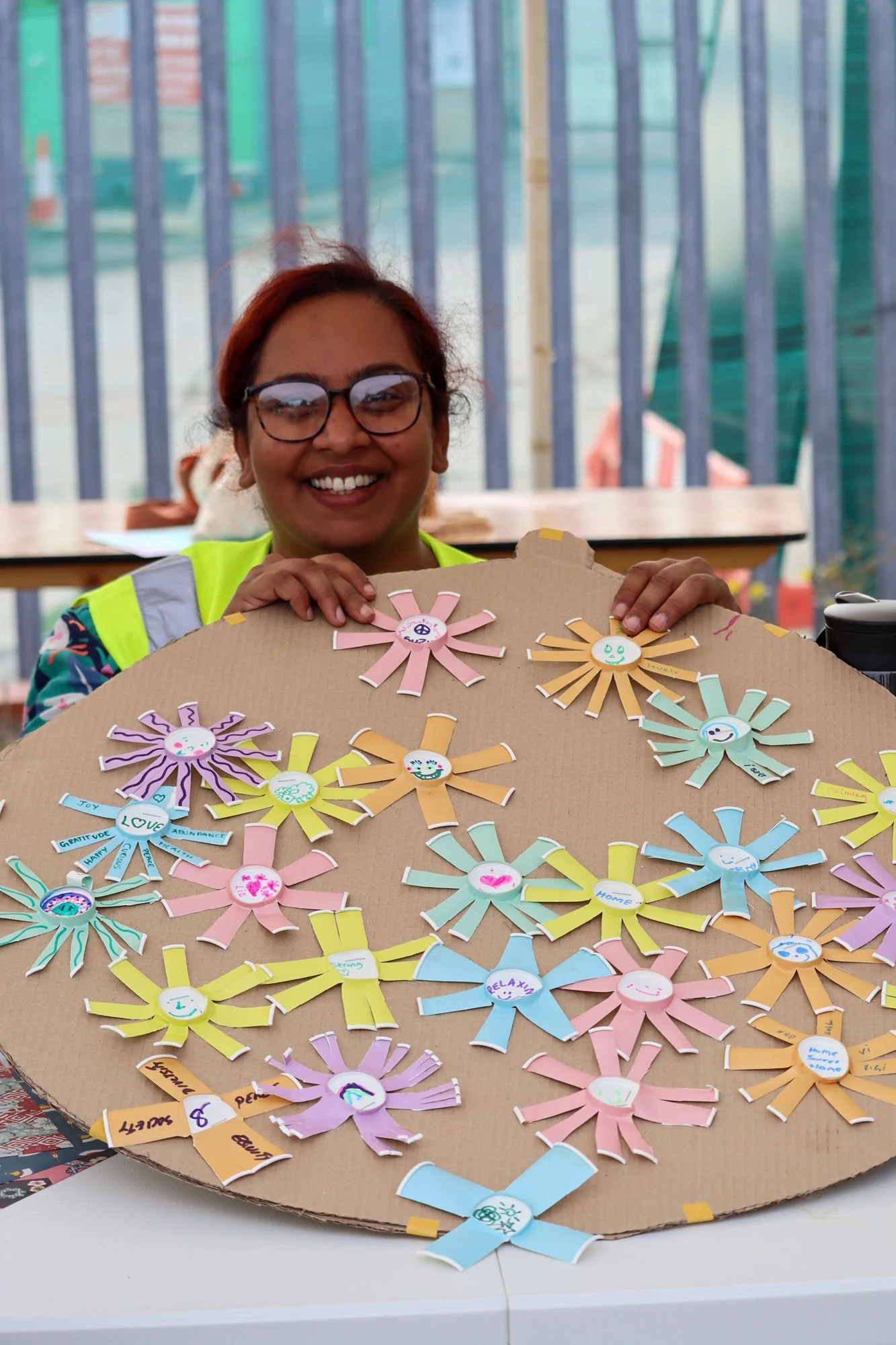 Anisha holding up the artwork for the community teapot.