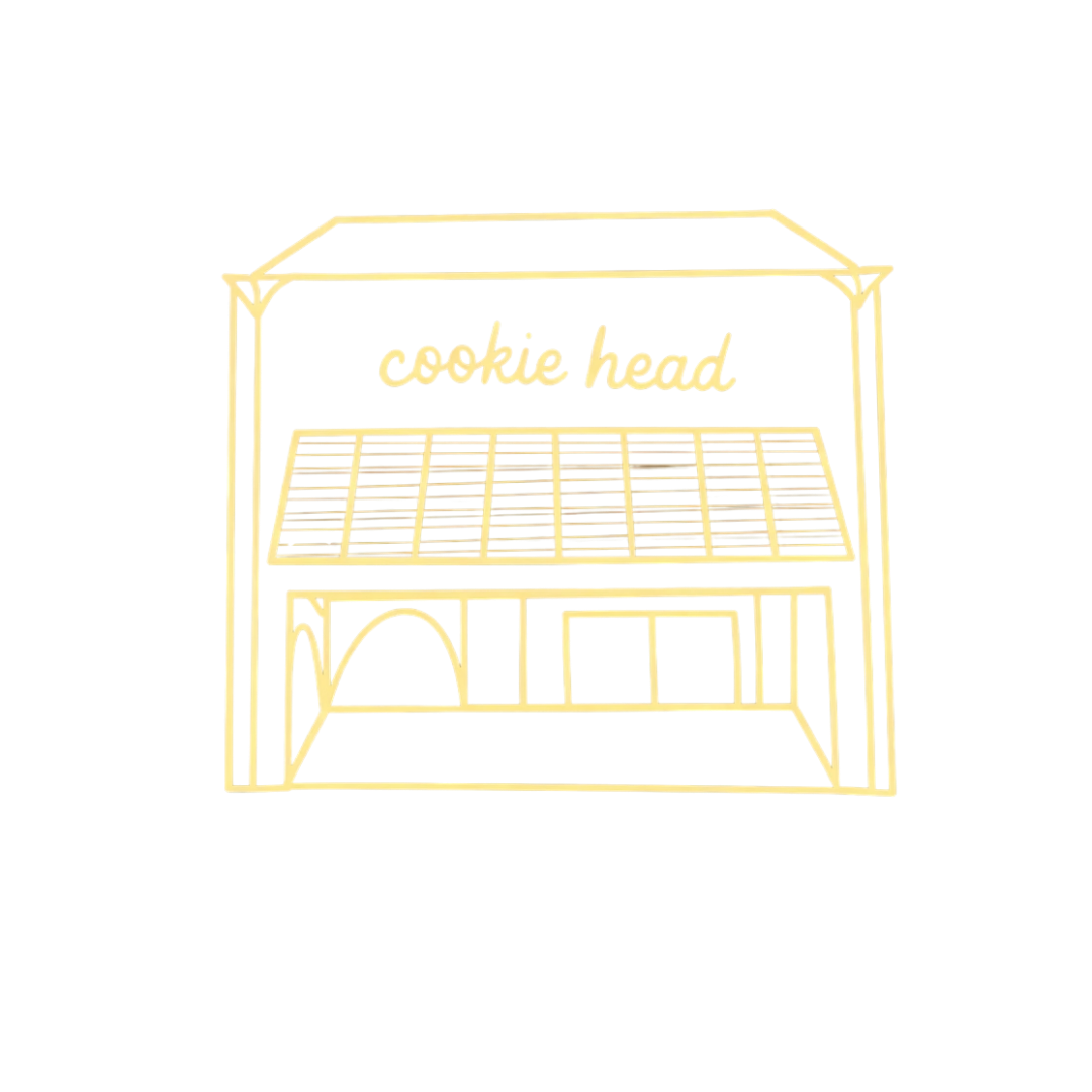 Storefront of a bakery named Cookie Head with awning.