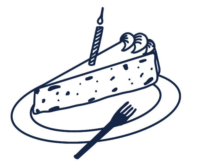 A slice of birthday cake with a lit candle on top, served on a plate with a fork beside it.