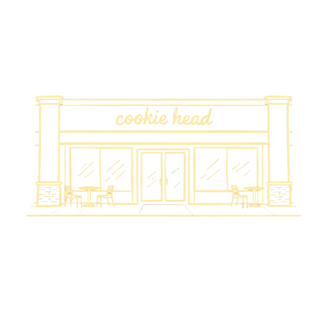 Storefront of a bakery named Cookie Head with decorative plants outside.