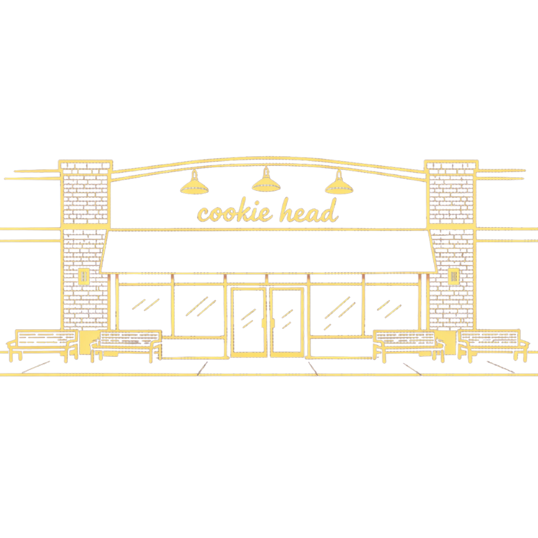 Storefront of a bakery named Cookie Head with decorative plants outside.