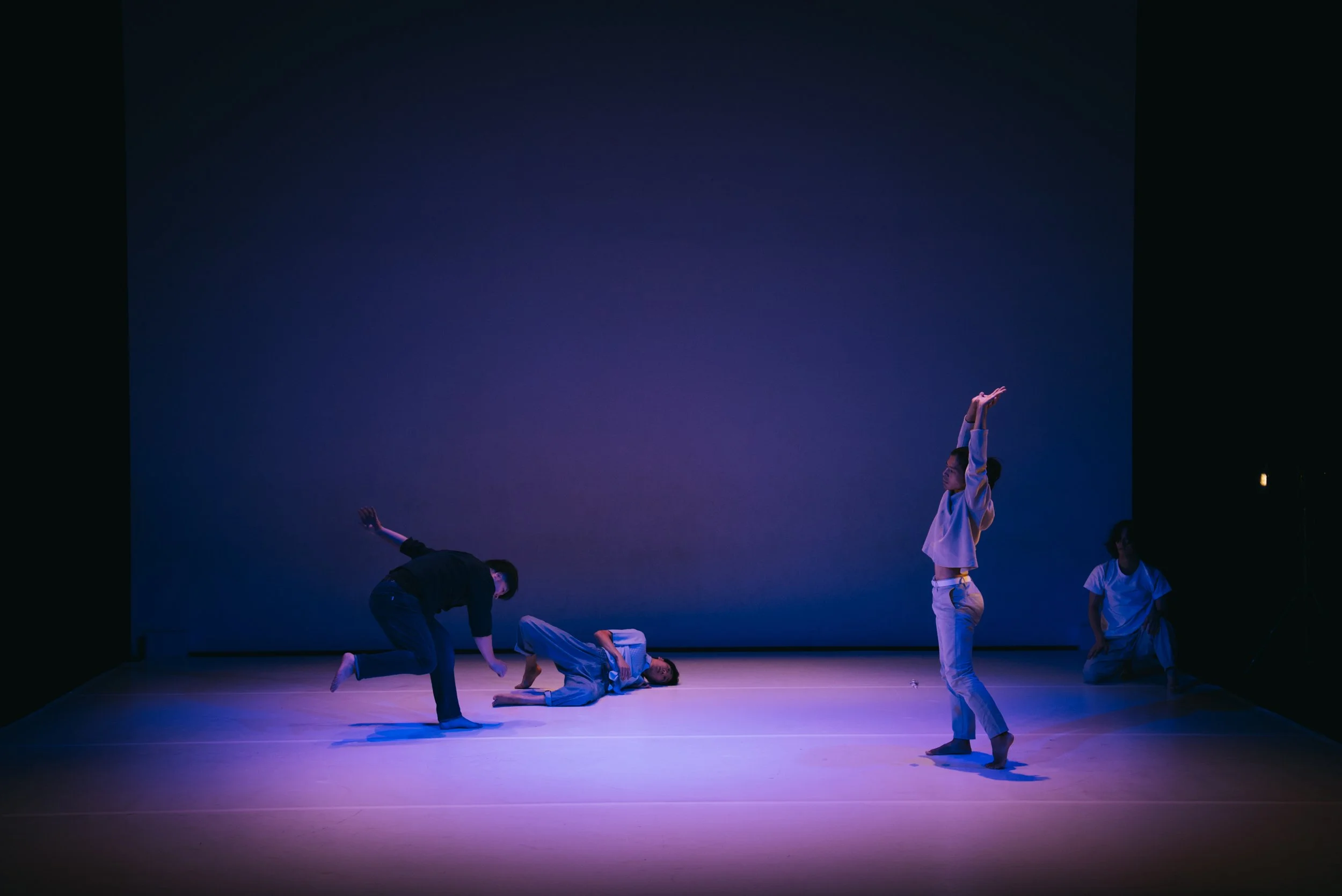 Four dancers improvising on stage in Total Beings | Burning Hearts.