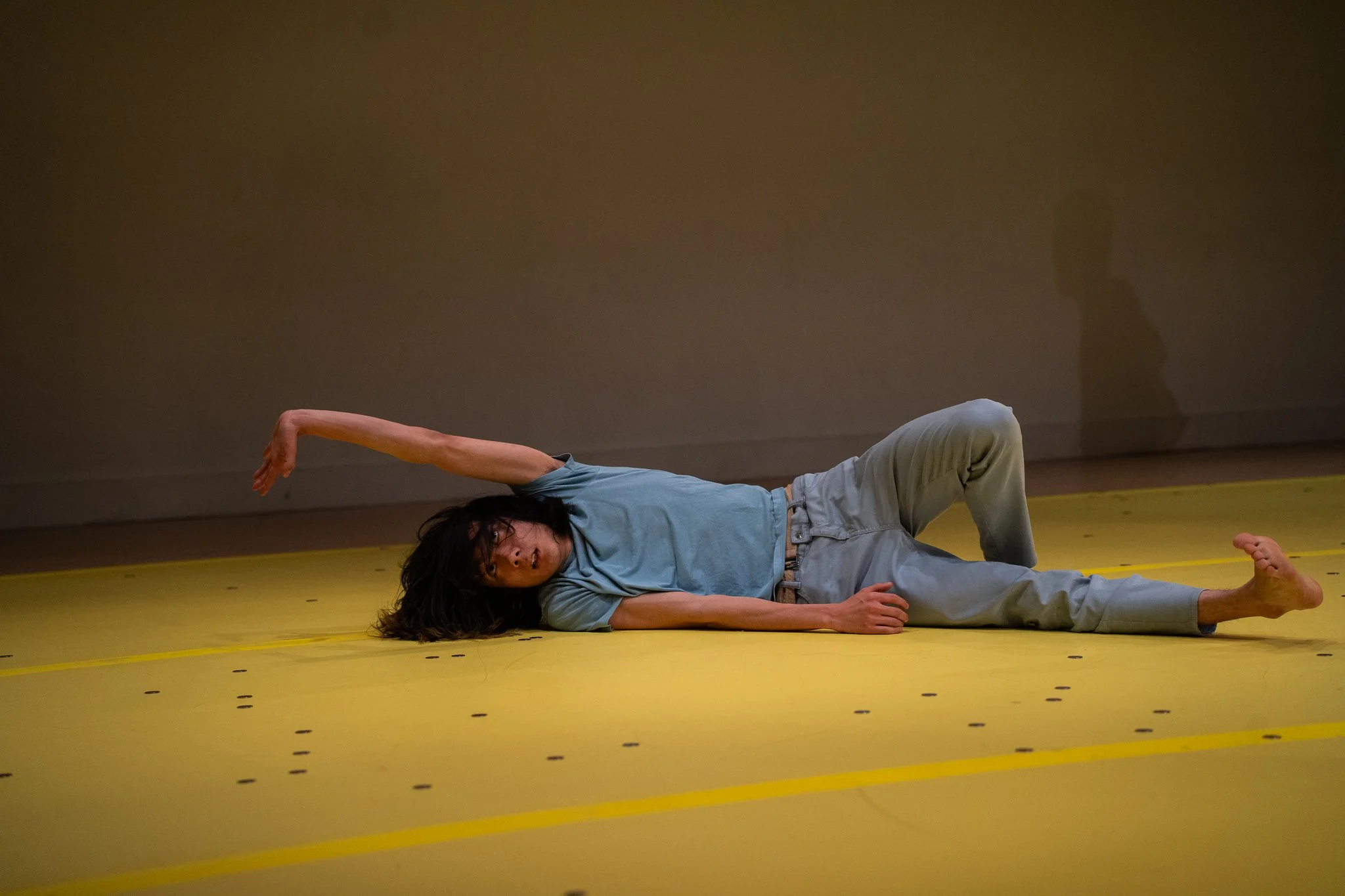 Daiki Sogawa is lying among scattered coins in The Righteous Beauty of the Things Never Accounted For.