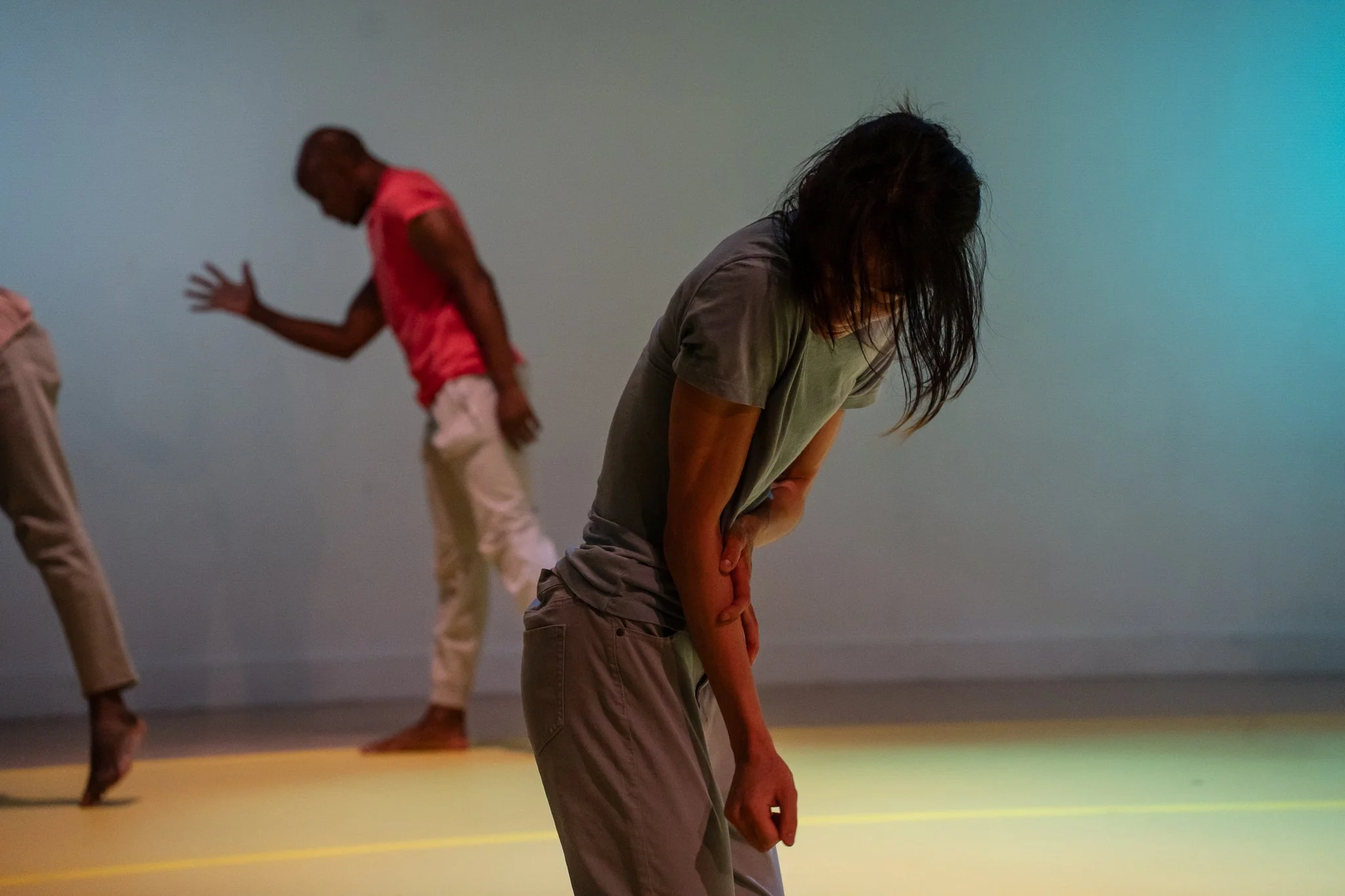 Three performers in a quiet ensemble moment in The Righteous Beauty of the Things Never Accounted For.