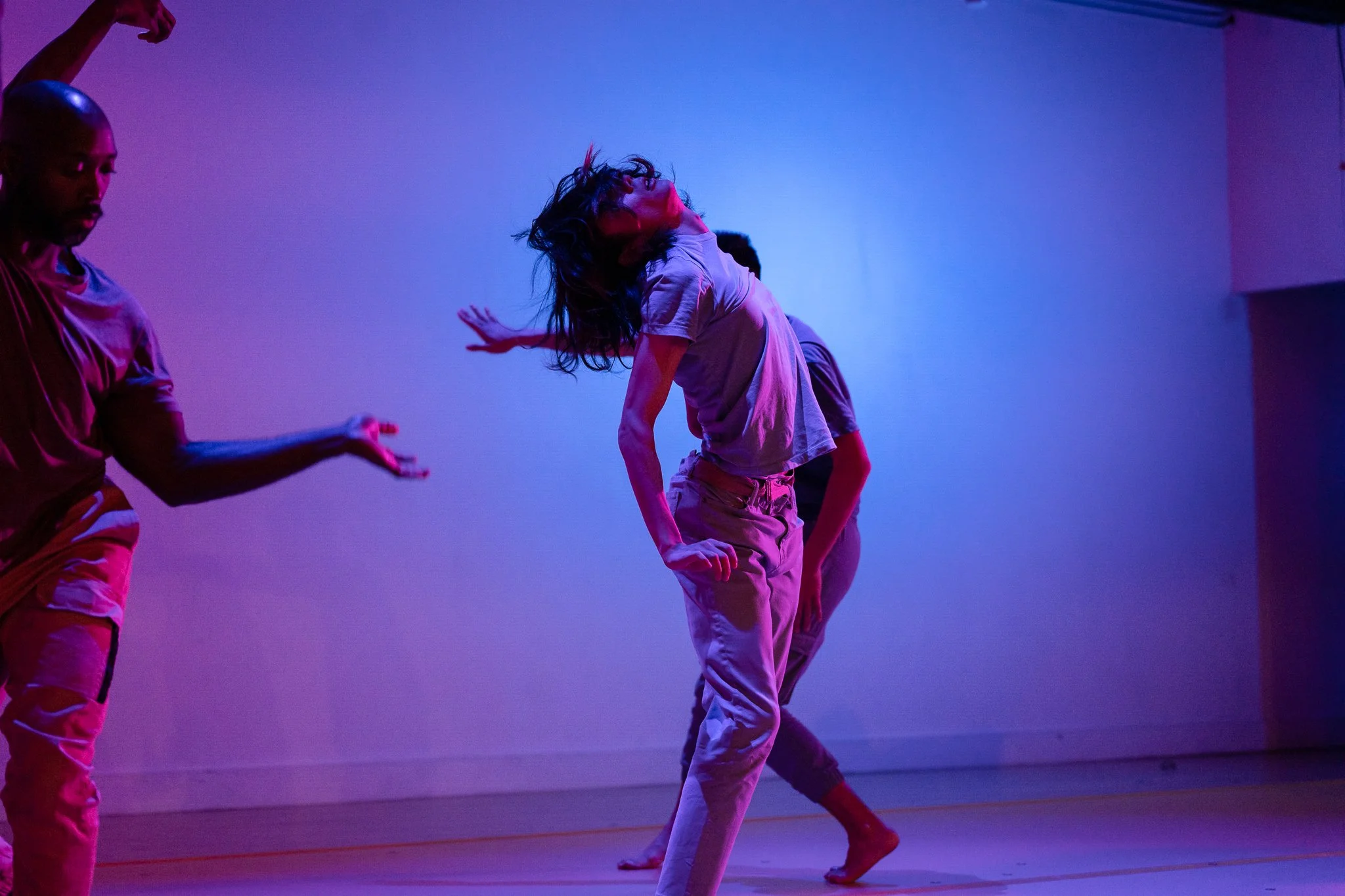 Ensemble choreography under purple and blue lighting in The Righteous Beauty of the Things Never Accounted For.