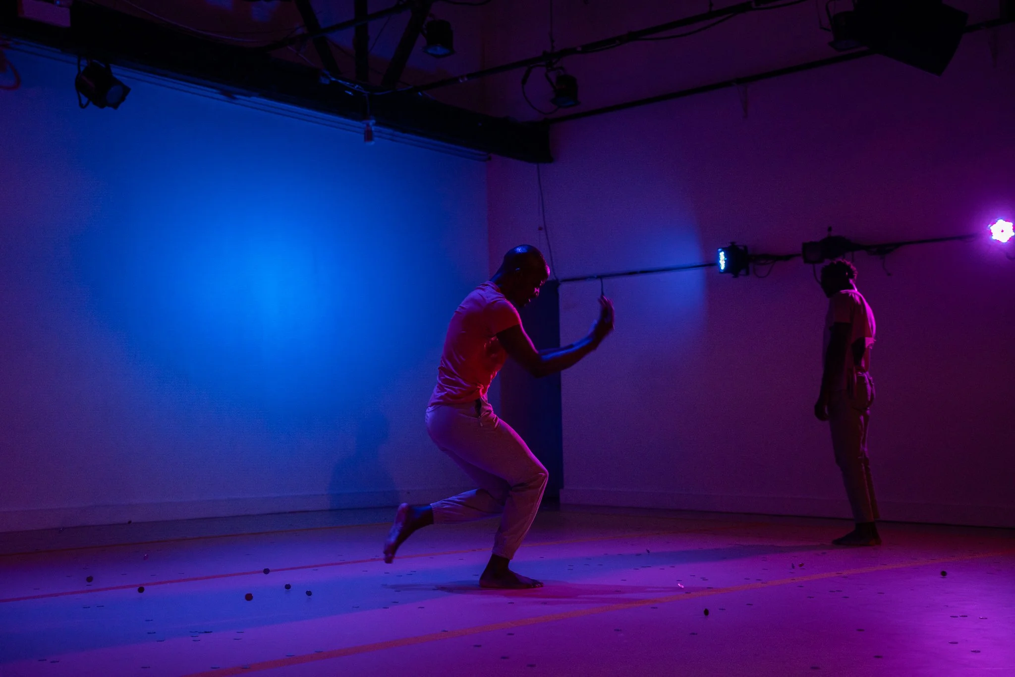 Two dancers performing contrasting movements on stage in The Righteous Beauty of the Things Never Accounted For.
