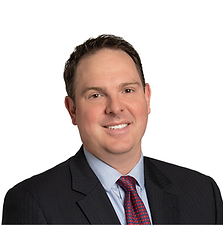 Professional portrait of a man in a suit with a dark background