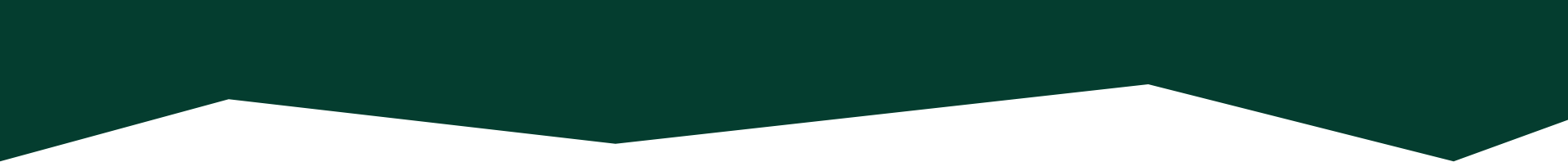 Silhouette of a mountain range with a dark sky in the background.