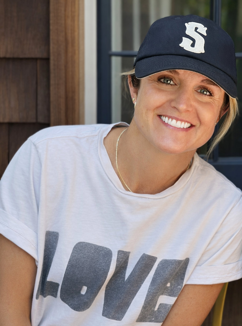 Stephanie Wilhite, MA, SLP — founder of Connection Club, wearing a blue baseball cap and smiling warmly