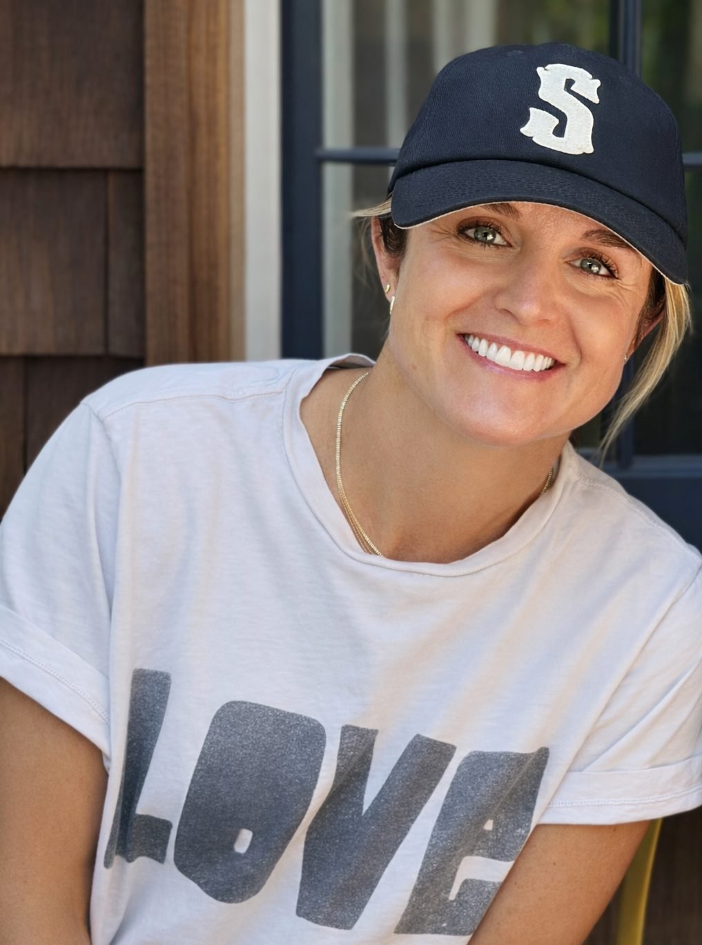 Stephanie Wilhite, MA, SLP — founder of Connection Club, wearing a blue baseball cap and smiling warmly