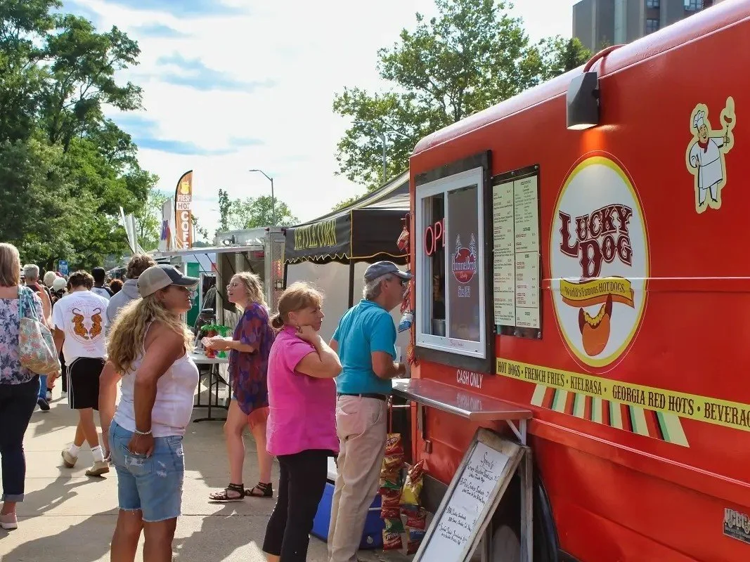 two people ordering at the window of lucky dog food truck