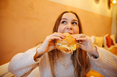 woman eating chicken sandwich