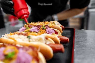 Chef squirting ketchup hot dog hotdog