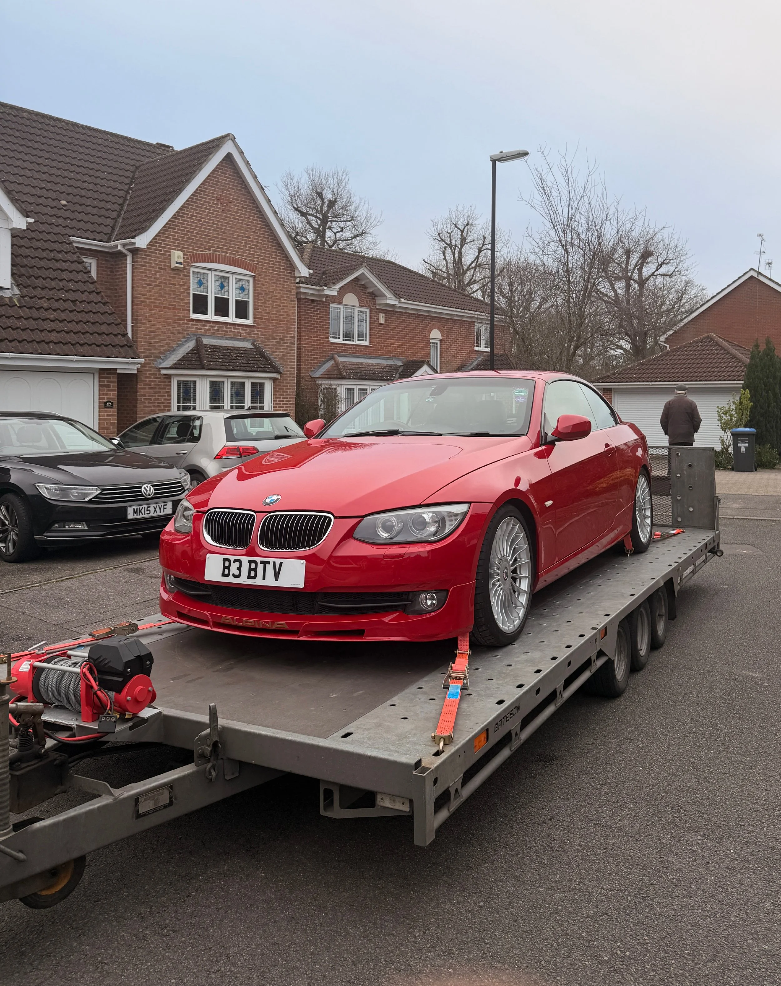 Red BMW on a trailer