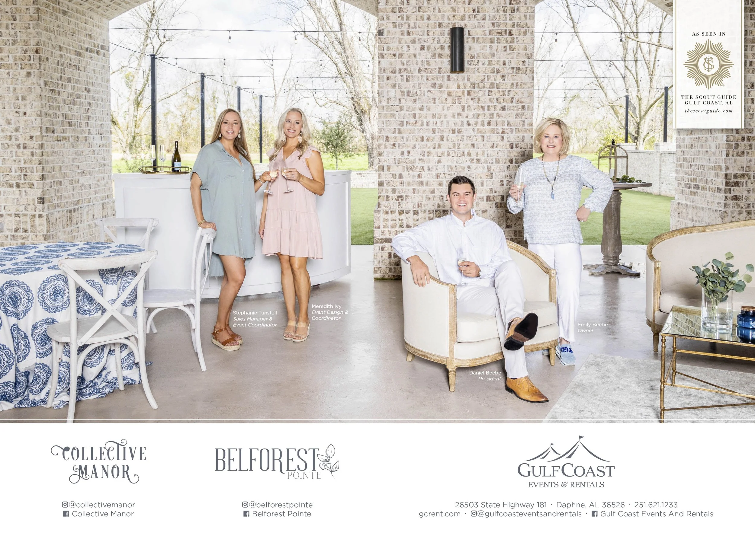 A group of five people in a bright, modern indoor setting with large windows showing an outdoor green landscape. Four women and one man, all dressed in semi-formal attire, are smiling and holding drinks. Some are standing near a white bar, and one woman is standing near a table with a blue and white patterned tablecloth. The man is seated in a white armchair, wearing a white shirt and light pants, holding a glass. The women are wearing pastel-colored dresses and casual outfits. The setting has a brick wall, some modern furniture, and a sign indicating it is a venue called Gulf Coast Events & Rentals in Daphne, Alabama.
