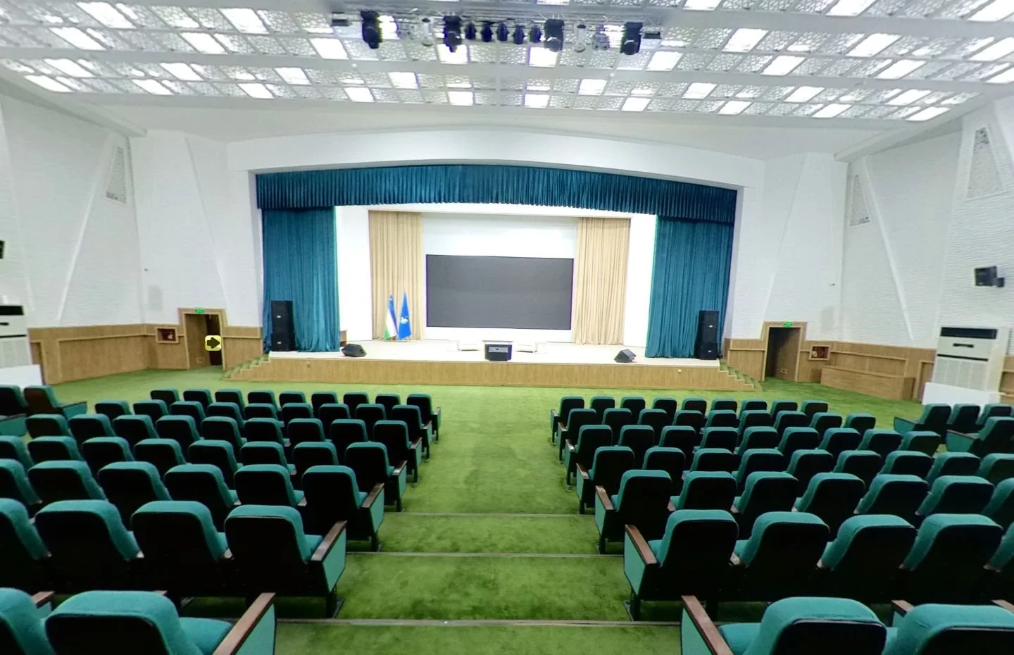 Tiered seating, stage and presentation screen in a TIIAME National Research University auditorium