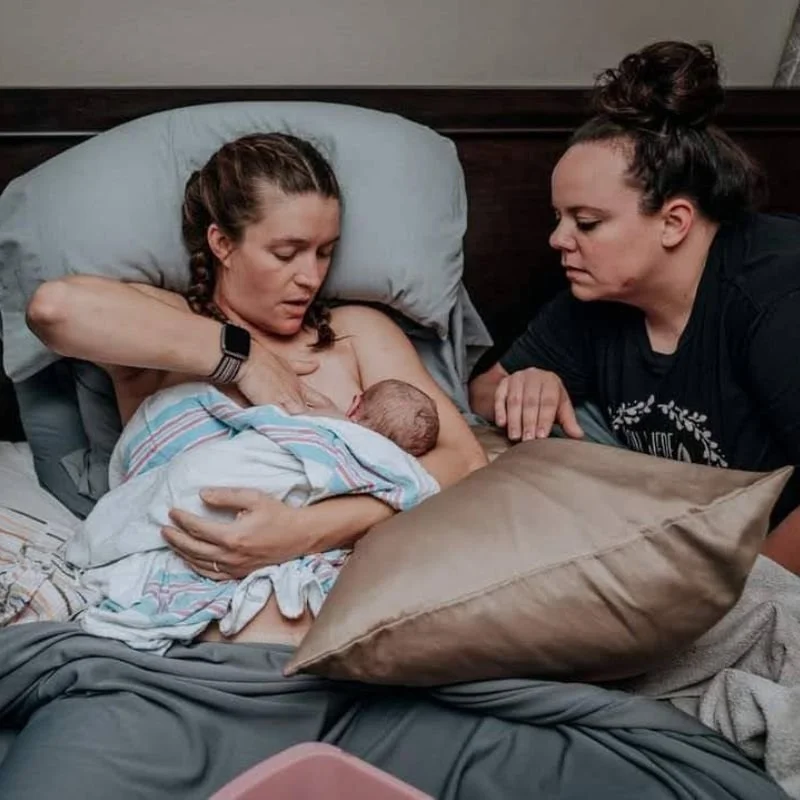 Newborn baby latching on mom