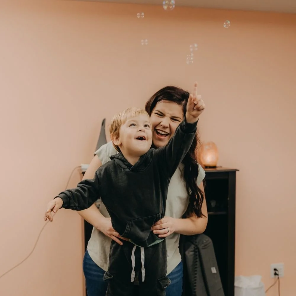 Dr. Brauer laughing with a child