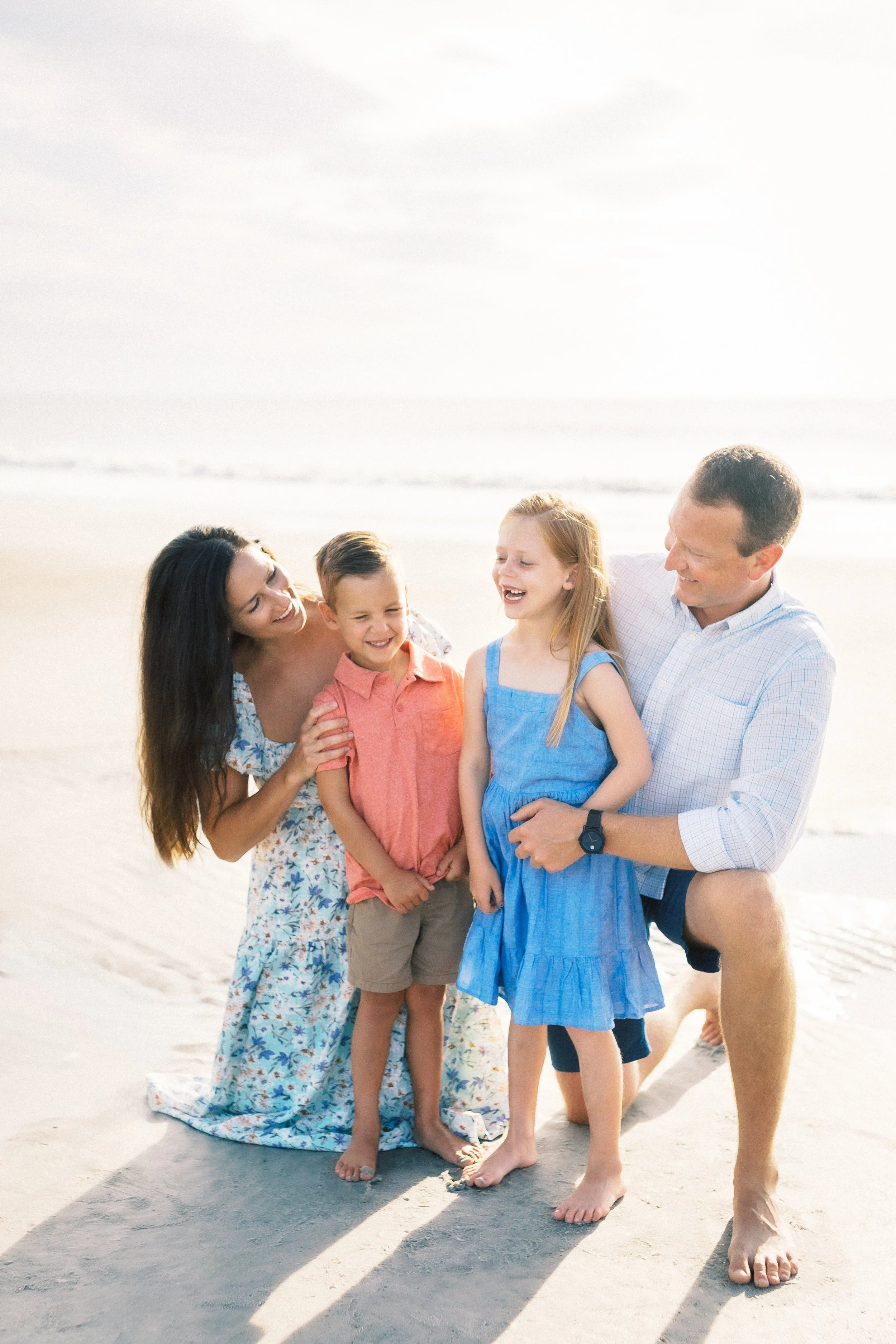 A family of five, including two adults and three children, enjoying a sunny day on the beach. Photographer Amelia Island, Jacksonville, St Augustine, St Simons Island, Savannah photographer