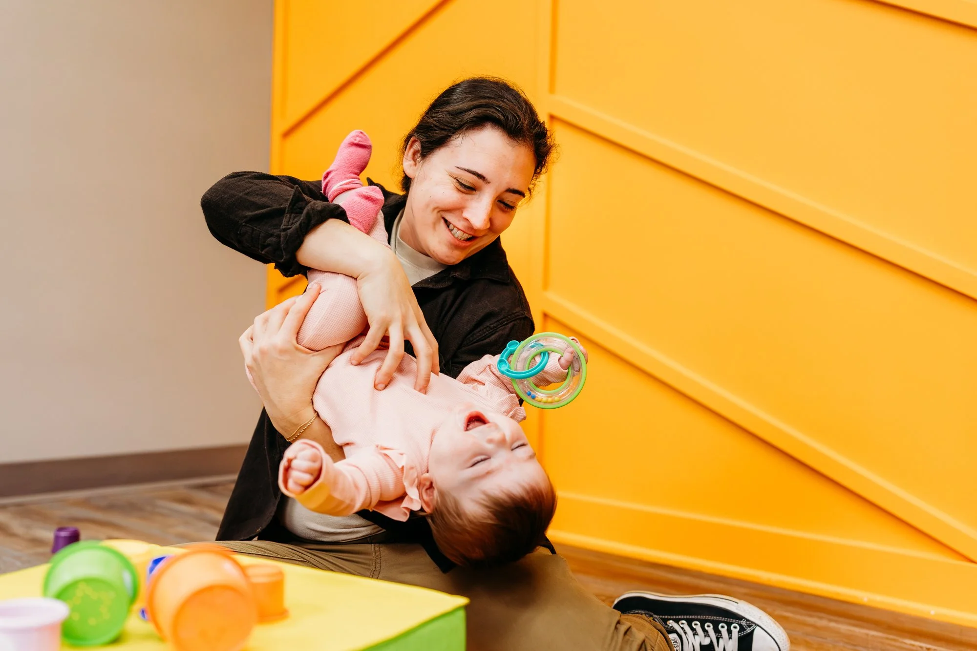 Dr. Gabi playing with baby during pediatric physical therapy session